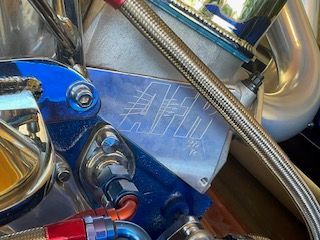 Close-up of a shiny engine area with blue and silver components.