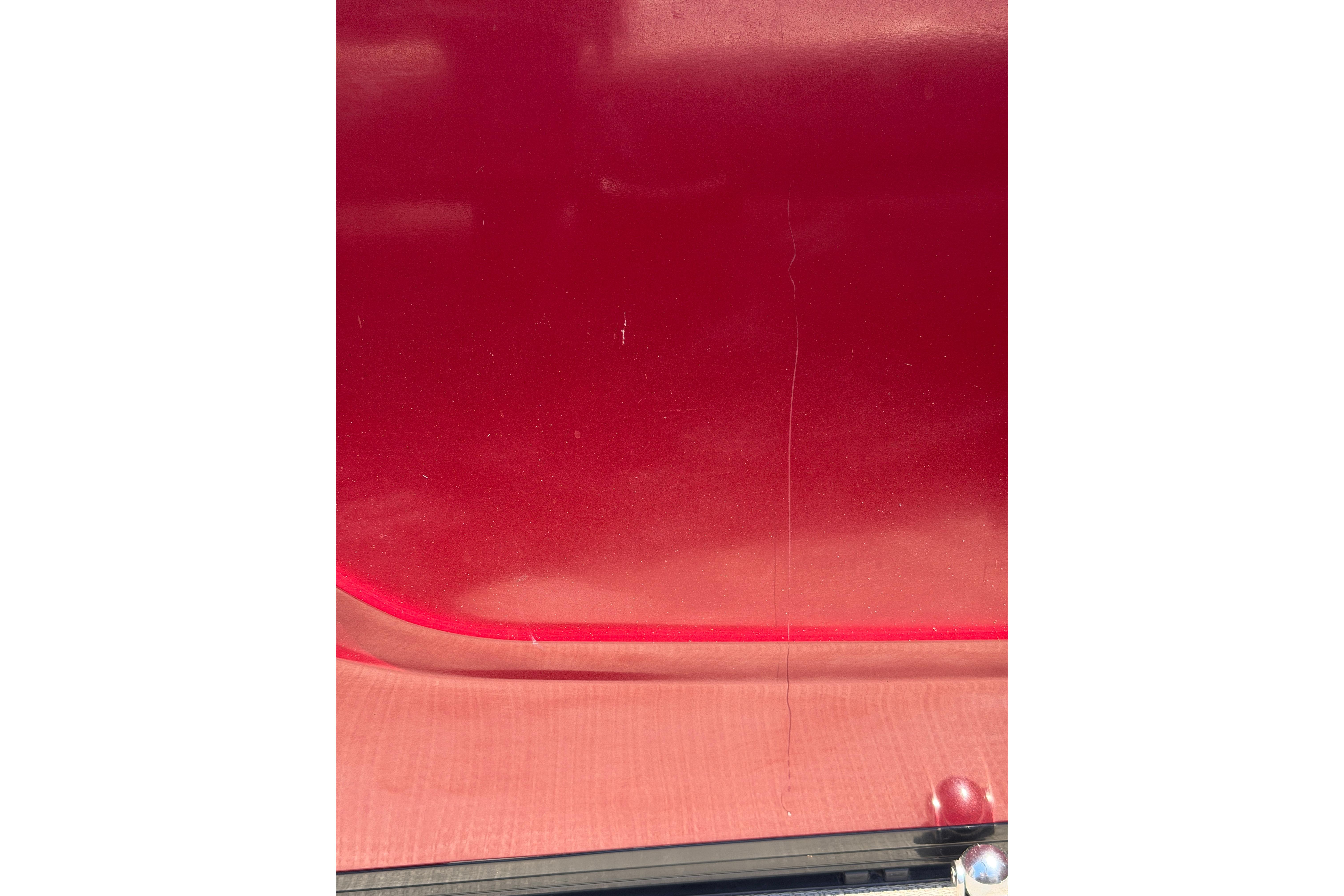Red exterior of 2024 Regency R250DL3 vehicle, showcasing sleek design and glossy finish.