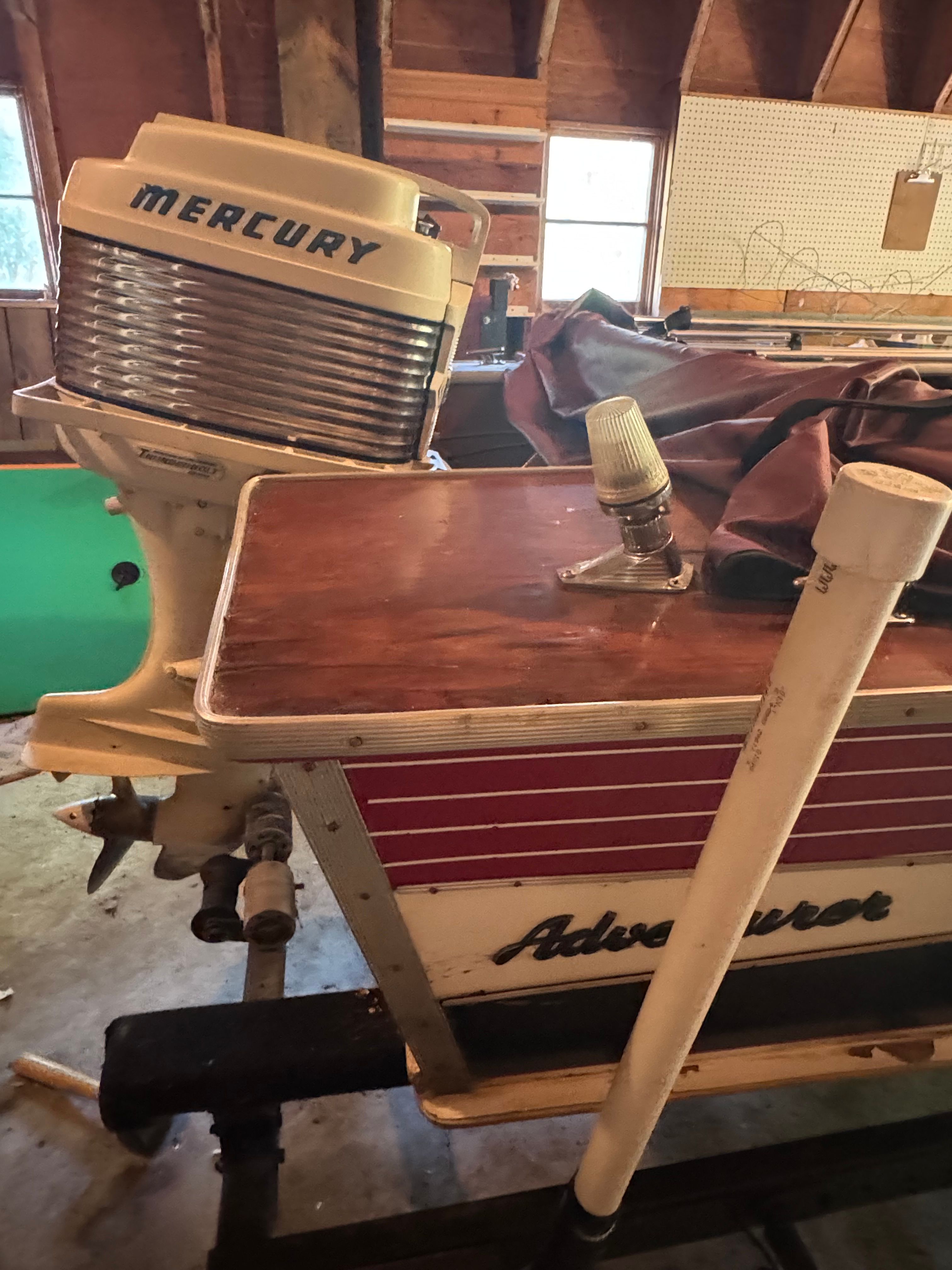 1958 Classic Sportcraft Runabout with Mercury engine in a garage.
