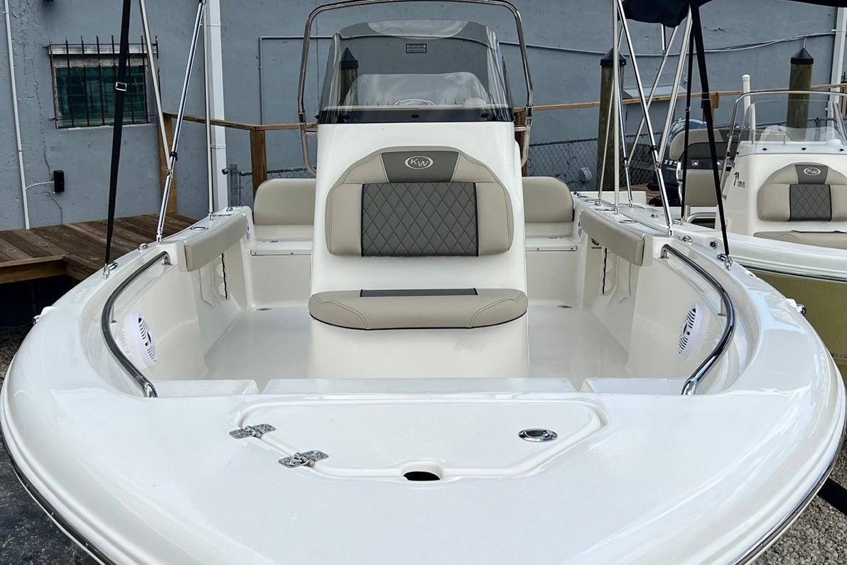 2026 Key West 189 FS boat with cushioned seating and sleek design in a marina setting.