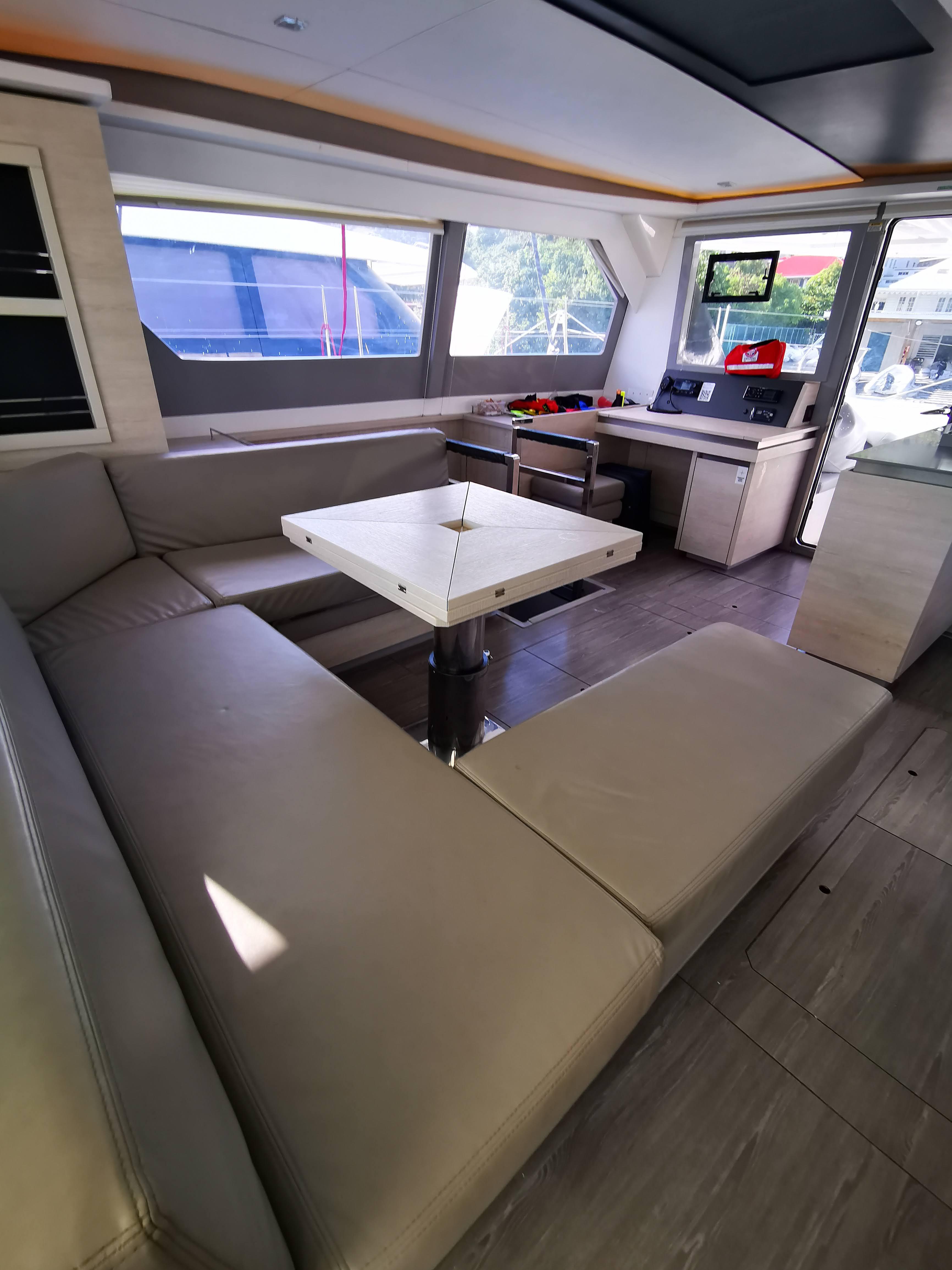 Luxurious interior of 2021 Leopard 50 yacht with modern seating and dining area.