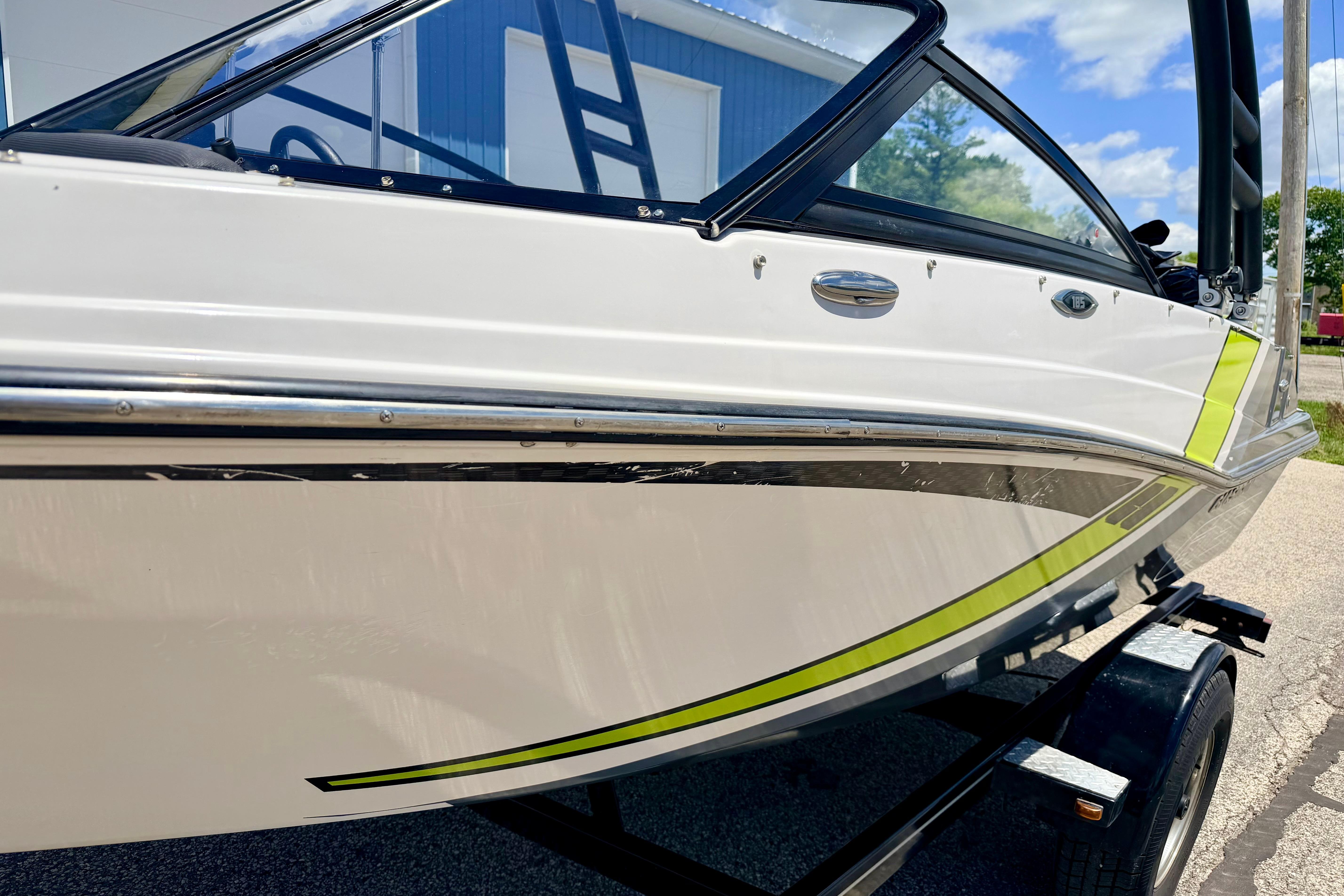 2018 Glastron GT 185 boat with sleek design and vibrant accents on a trailer.