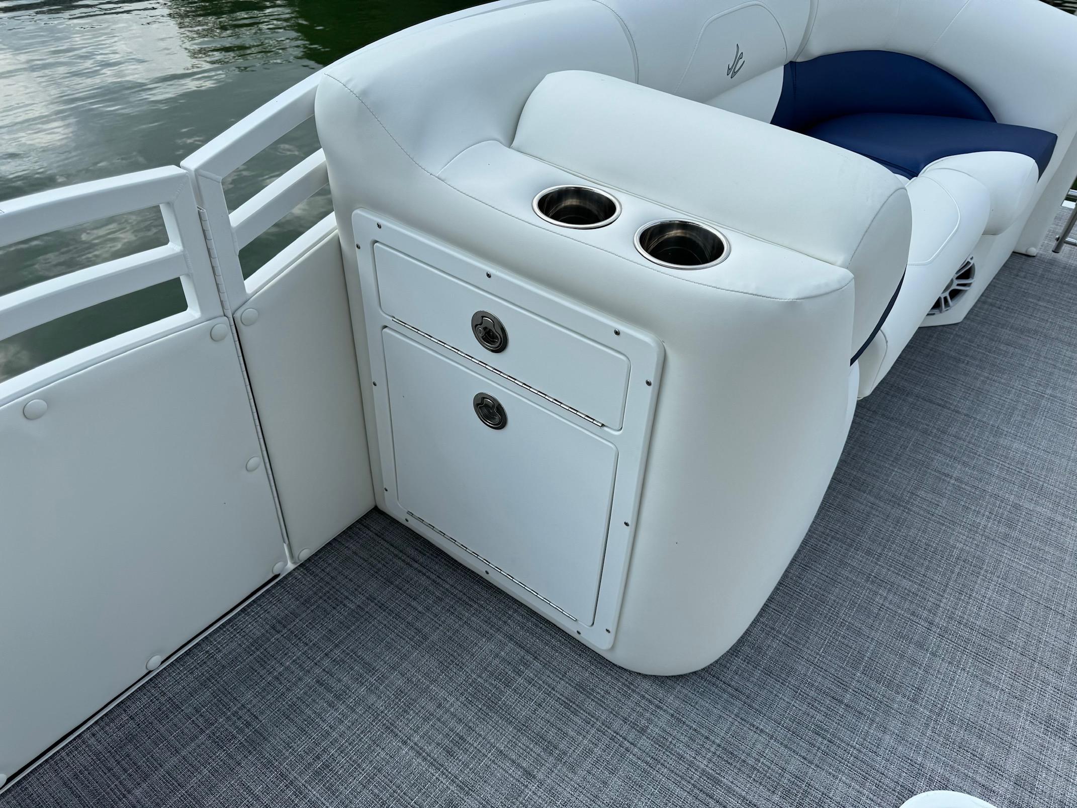 2024 JC Spirit Super Sport 24TT DSL boat interior with cup holders and storage.