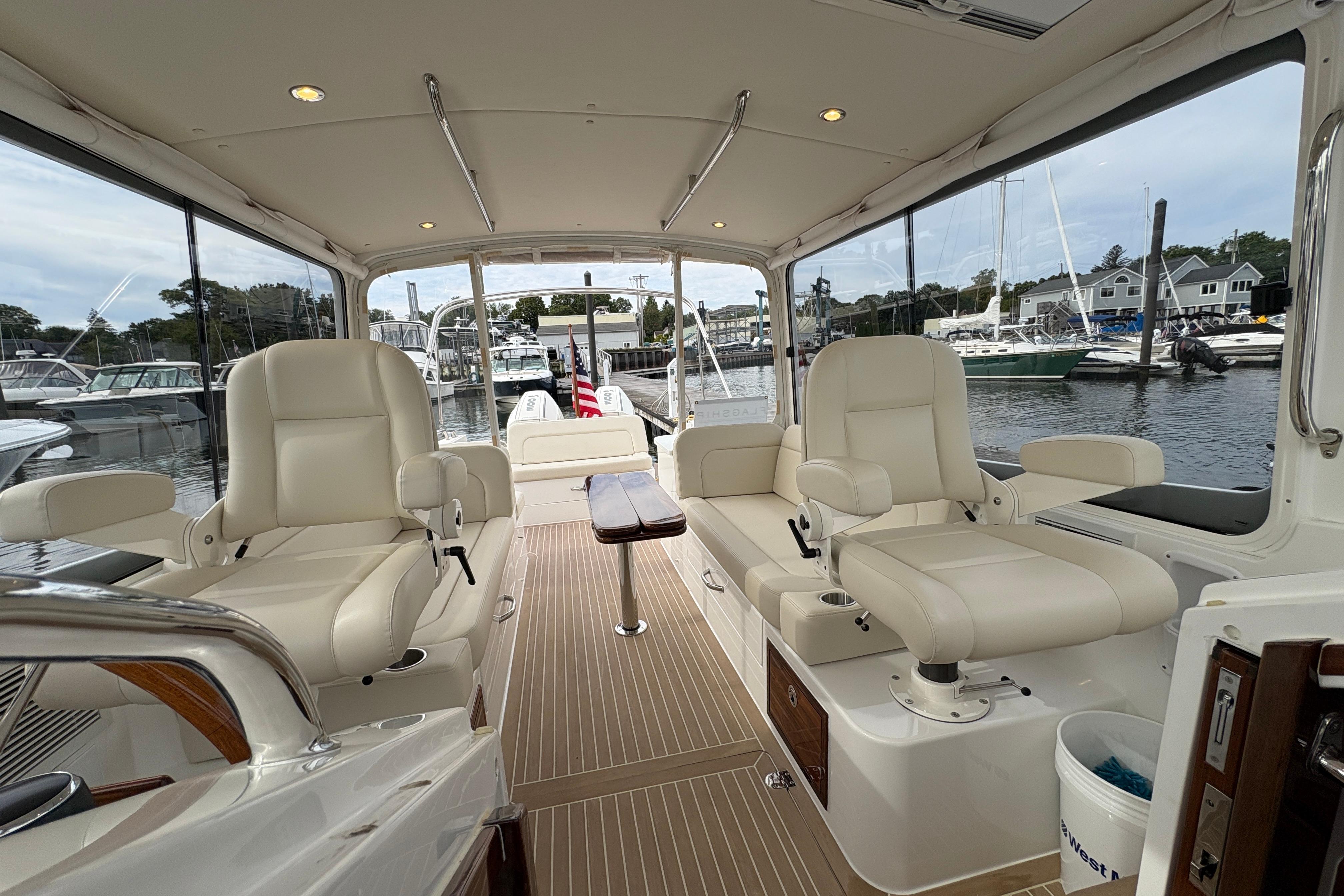 Interior of 2023 MJM 35 yacht with luxurious seating and marina view.
