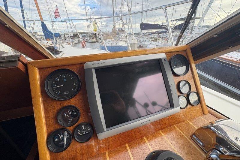 1987 Tollycraft 34 Sundeck Motor Yacht dashboard with gauges and Garmin GPS.