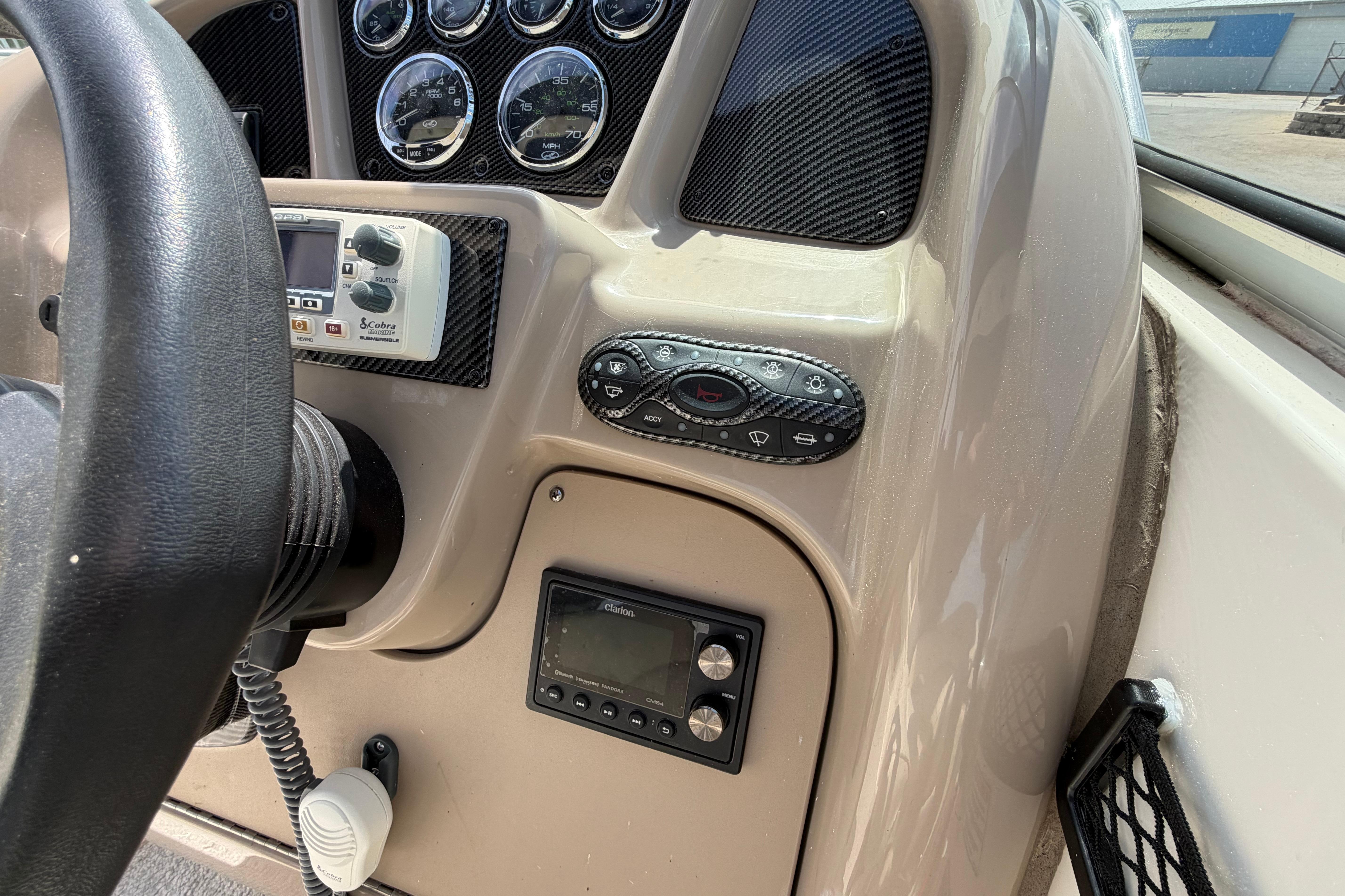 Dashboard of a 2004 Sea Ray Sundancer 260 boat with gauges and controls.