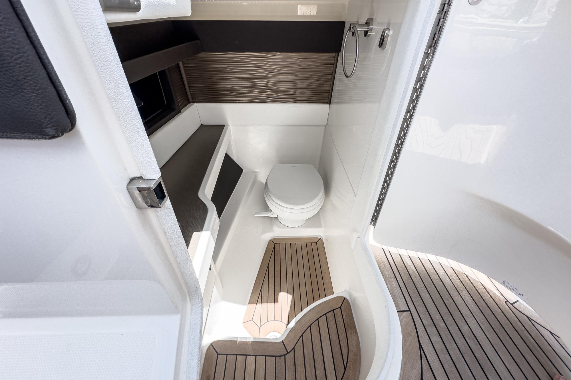 2018 Sea Ray SLX 310 boat bathroom with modern design and wooden flooring.