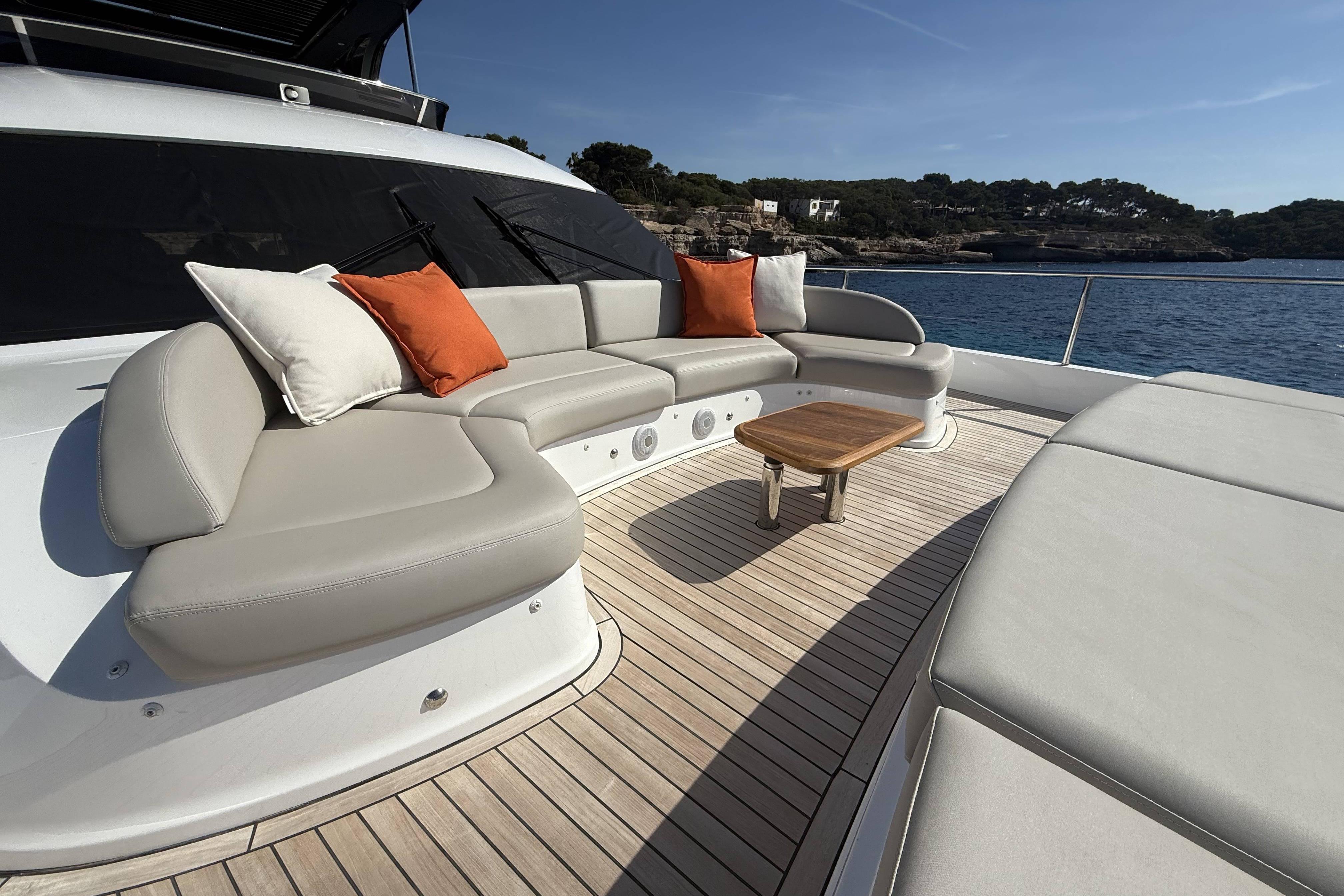 Luxurious 2025 Princess Y72 yacht deck with elegant seating and scenic ocean view.
