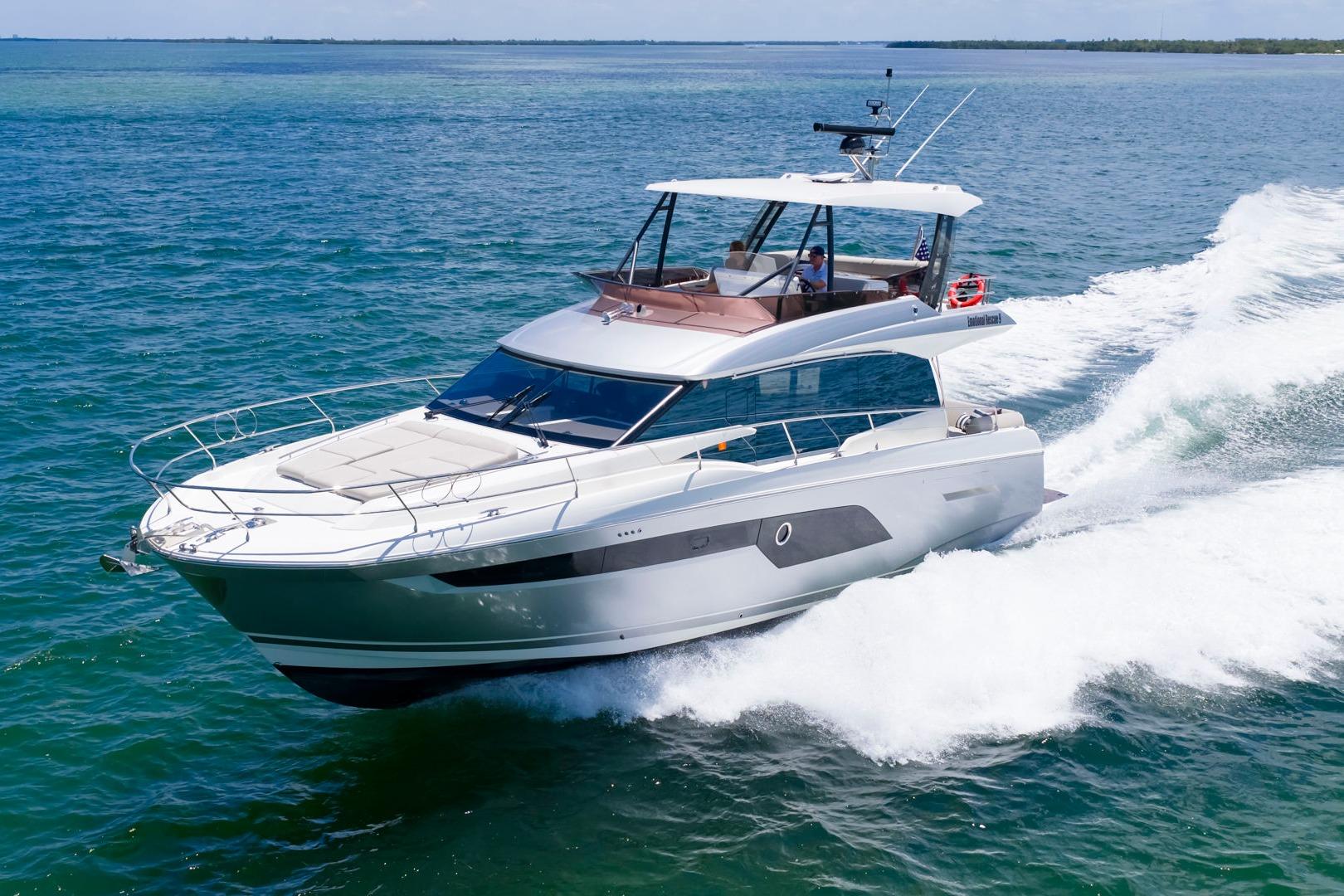 2022 Prestige 520 yacht cruising on open water, showcasing sleek design and luxury features.