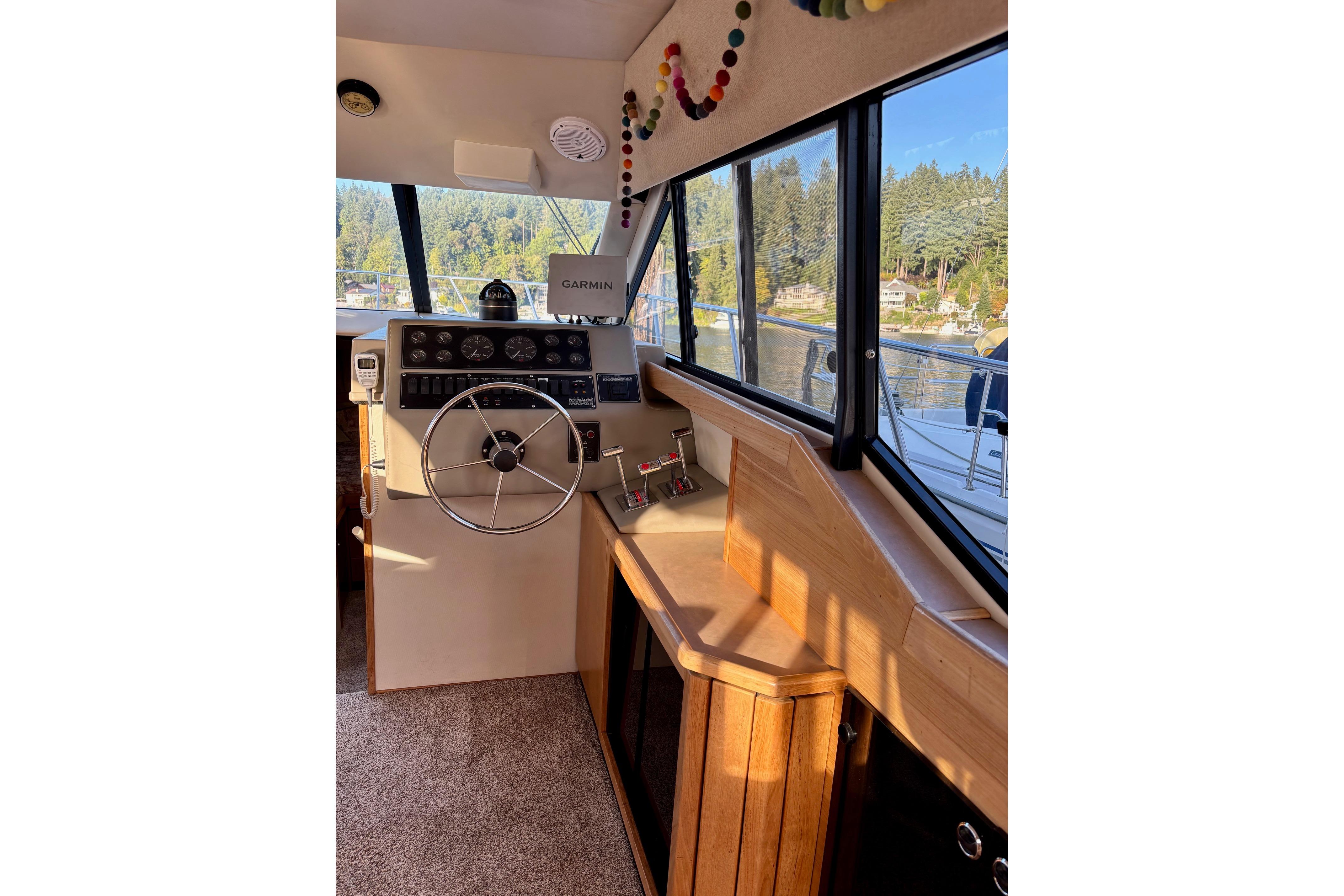 1998 Bayliner 3388 Command Bridge Motoryacht helm with steering wheel and navigation equipment.