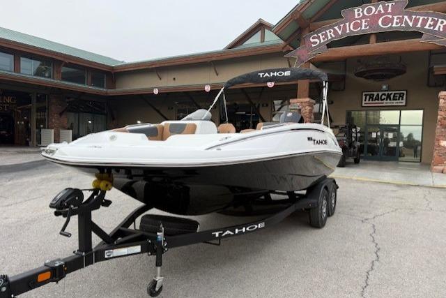 2026 Tahoe 1950 boat on trailer at service center entrance.