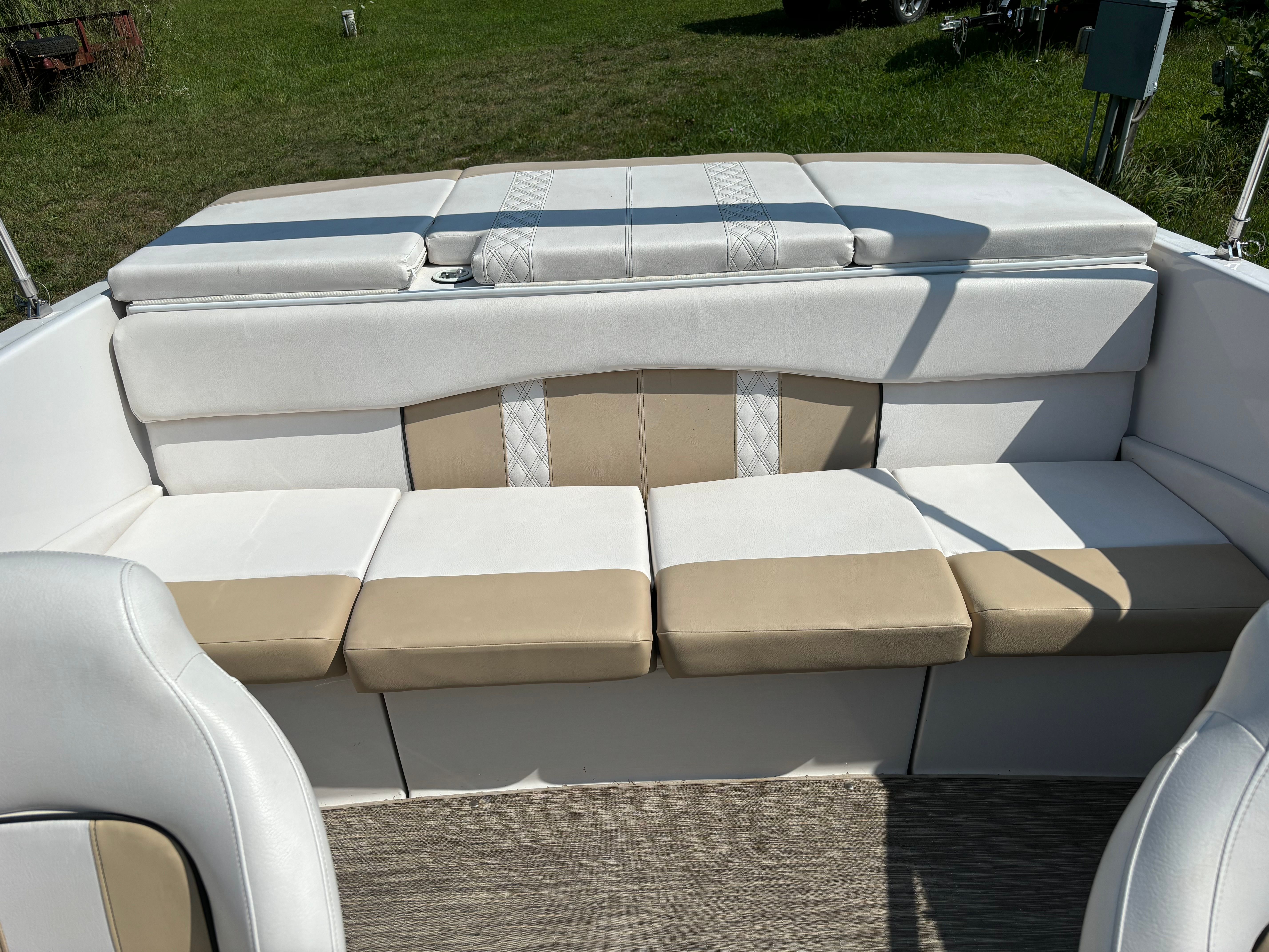 Interior view of a Glastron boat with beige and white seating.