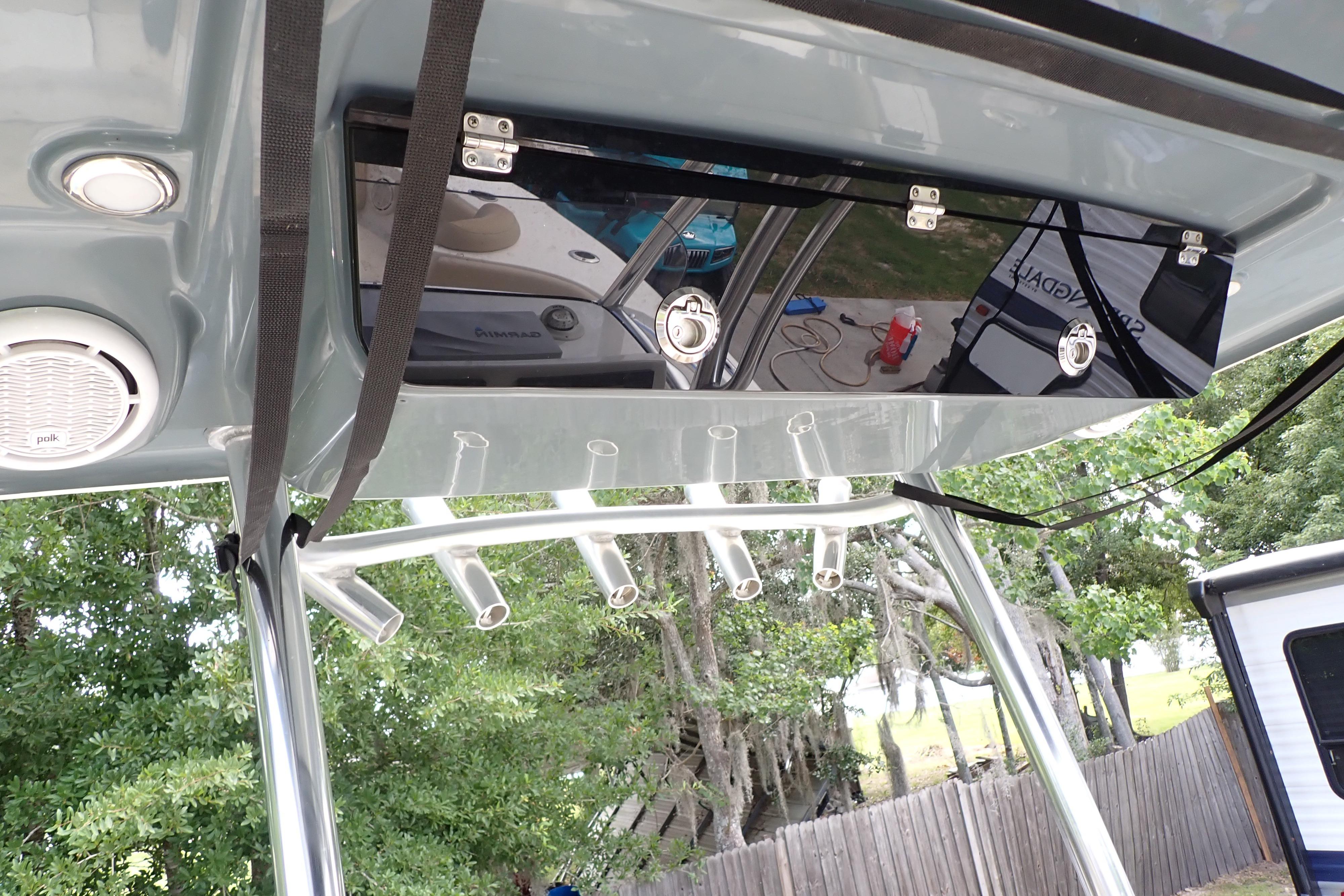 2019 Key West 263 FS boat T-top with rod holders and storage compartment.