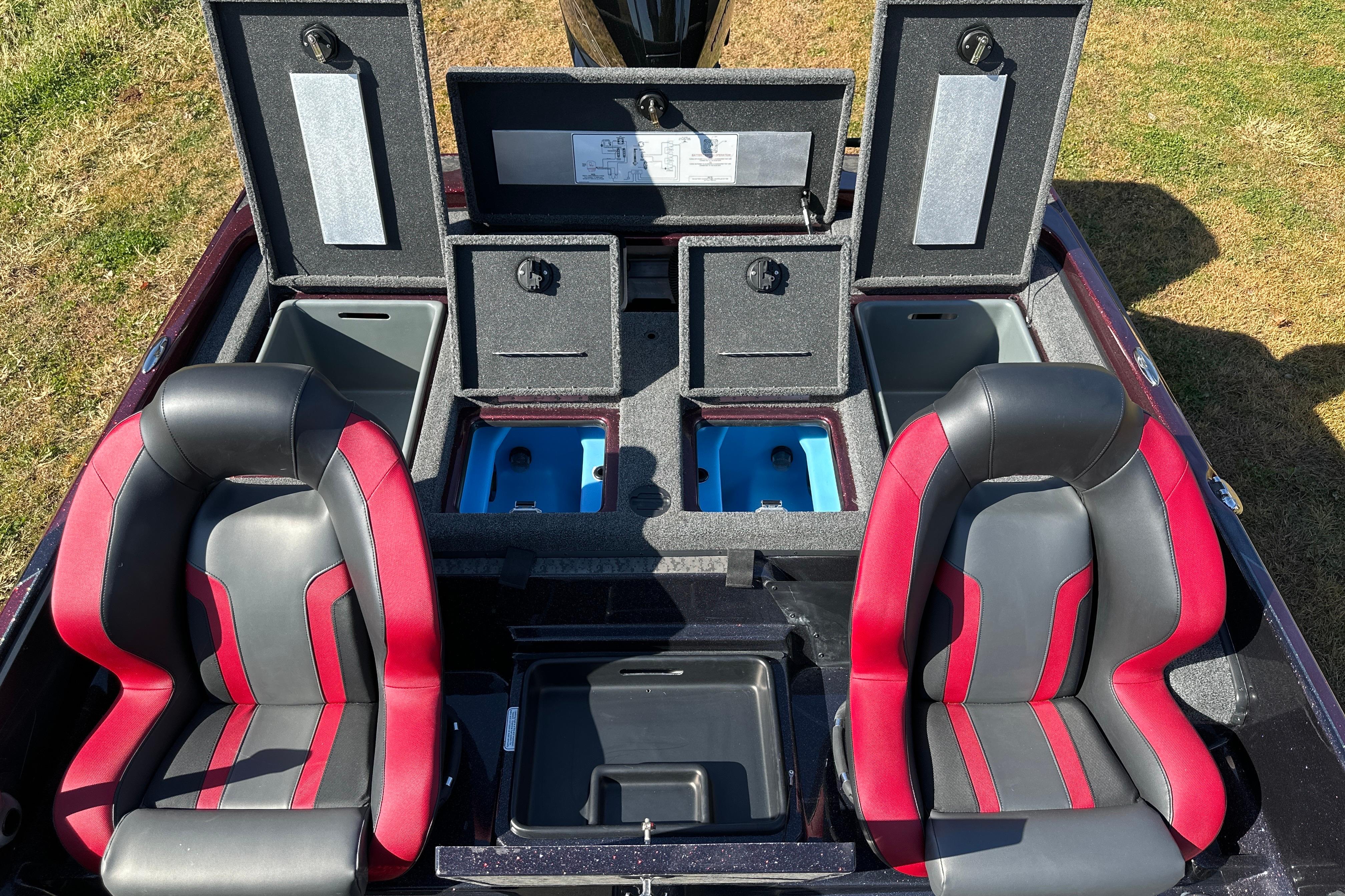 2026 Nitro Z21 XL Pro boat interior with storage compartments and red-black seats.