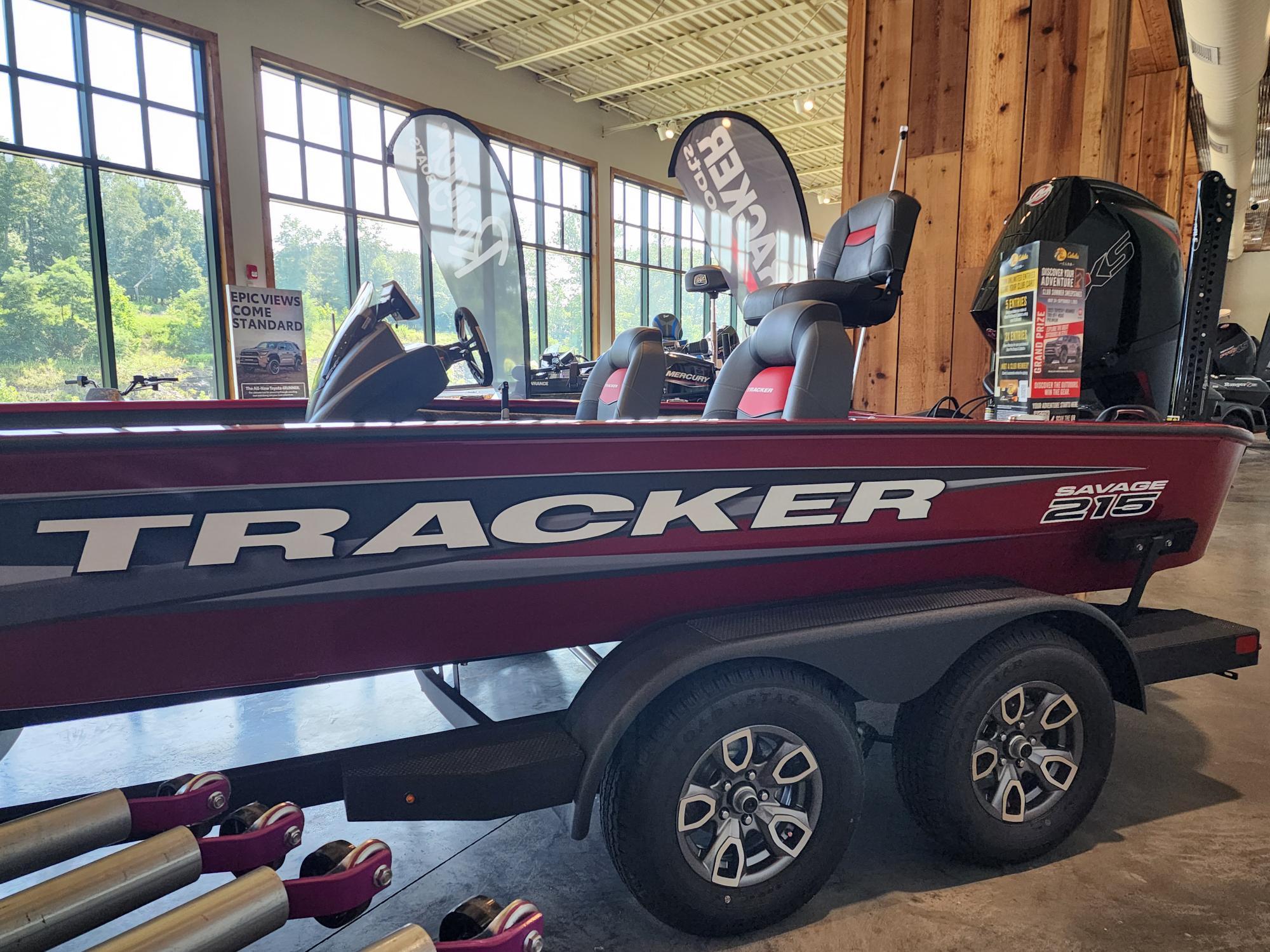 2025 Tracker Savage 215 boat displayed indoors, featuring sleek design and modern seating.