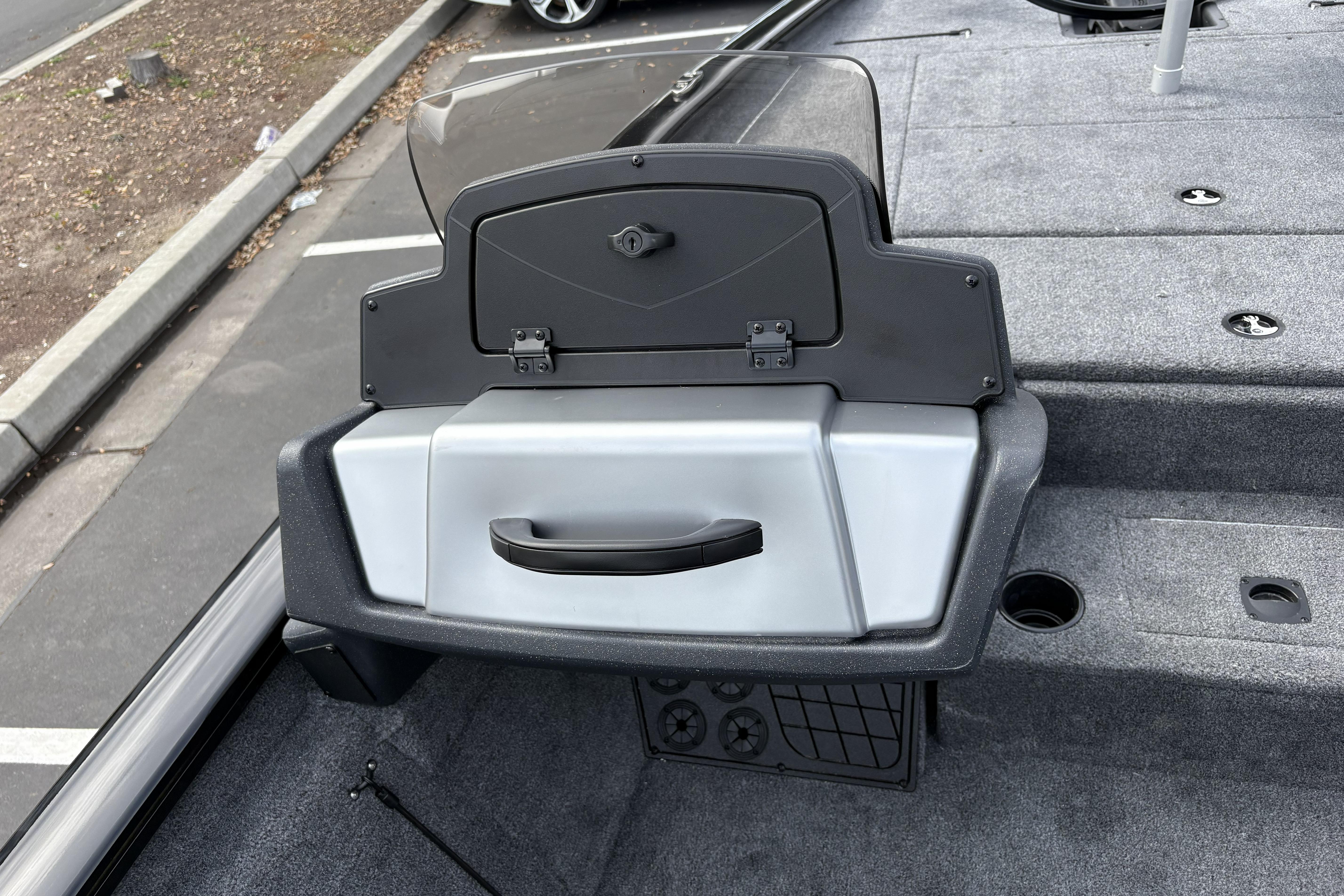 2026 Tracker Pro Team 195 boat console with storage compartment and gray carpeted deck.