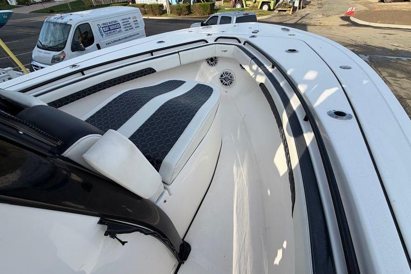 2023 Tidewater 282 CC Adventure Bluewater boat interior with cushioned seating and speakers.