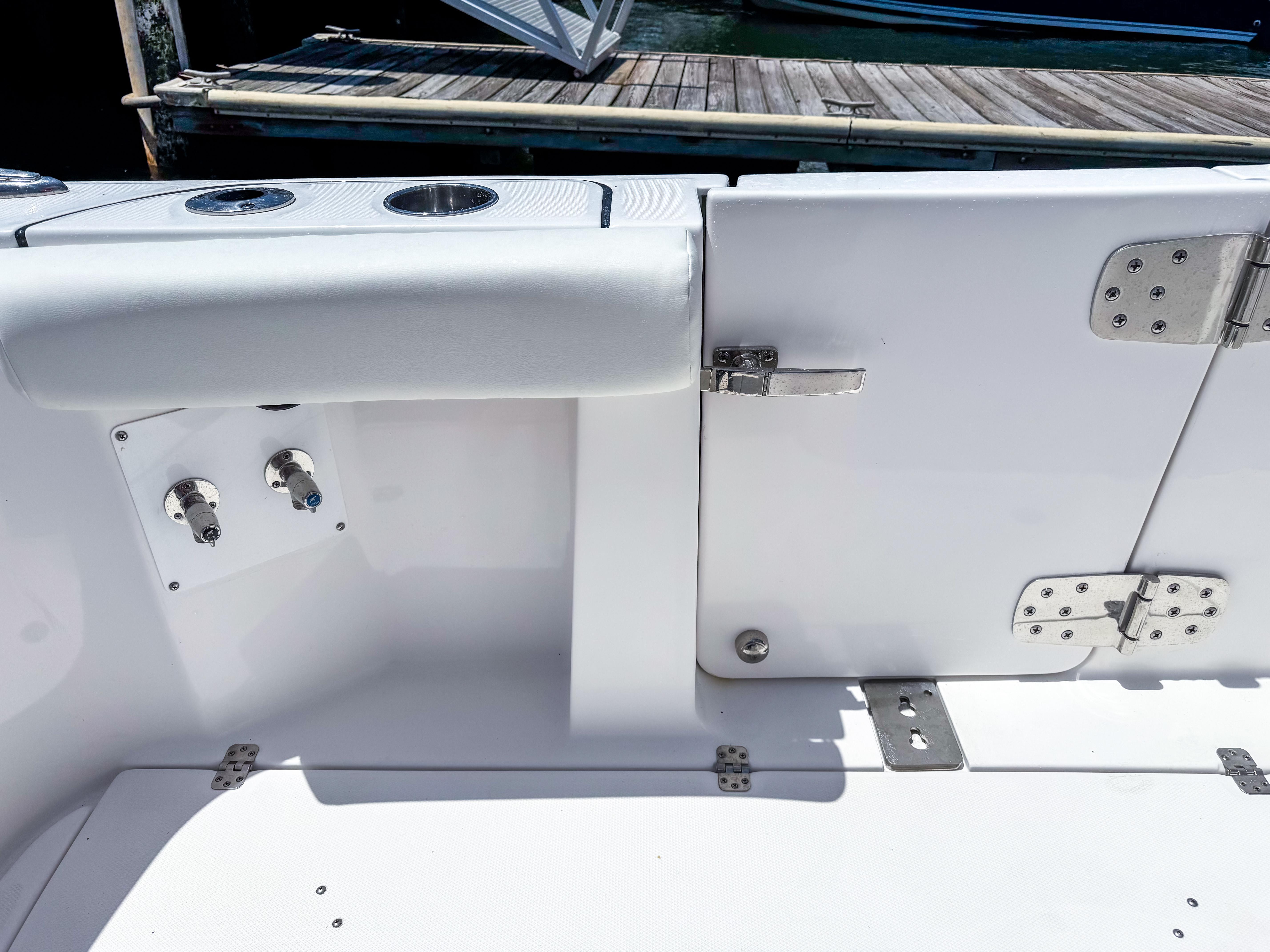 2025 Edgewater 370CC boat interior with stainless steel fixtures and dock view.
