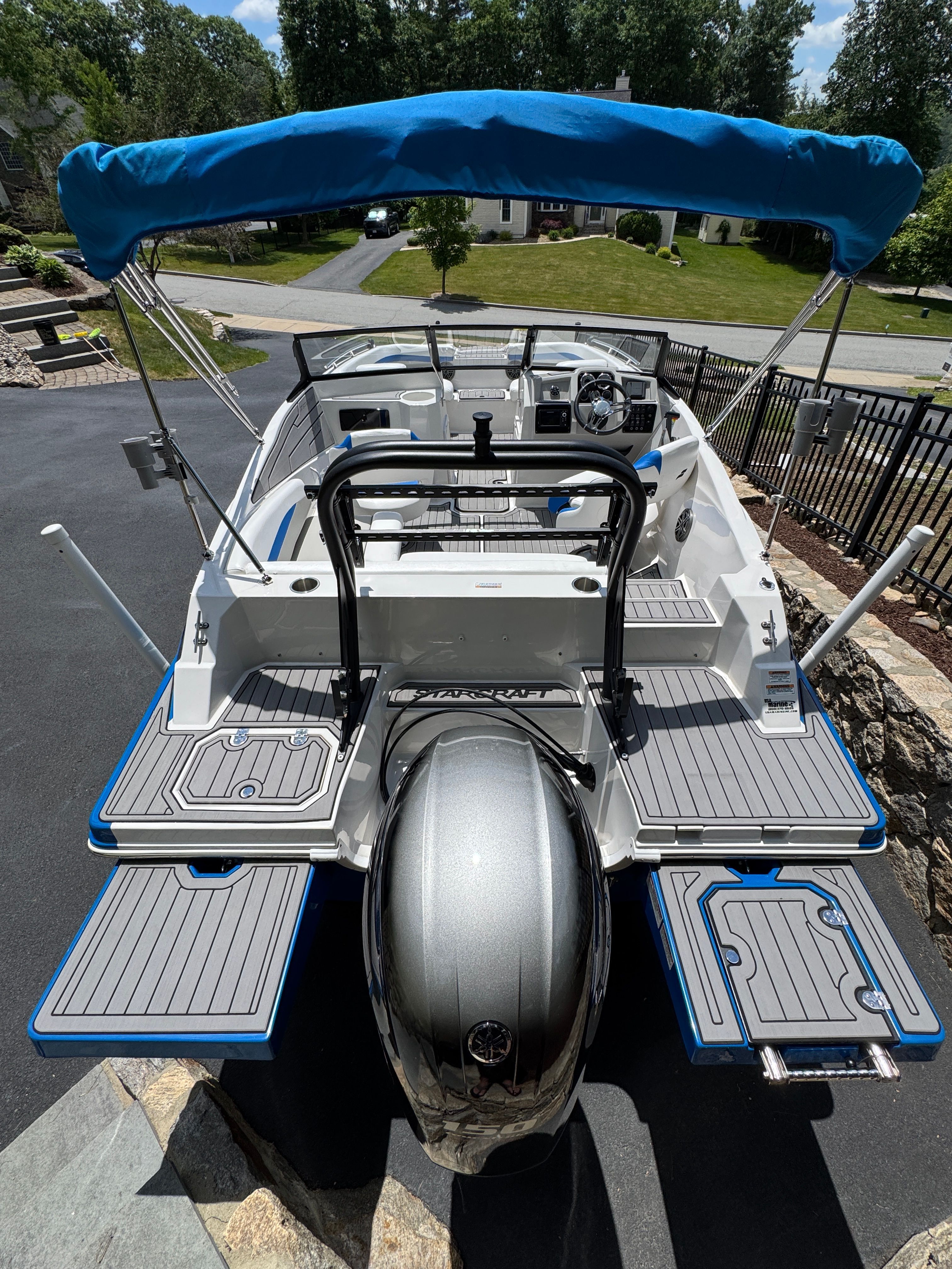 2023 Starcraft SVX 190 OB boat parked with blue canopy.