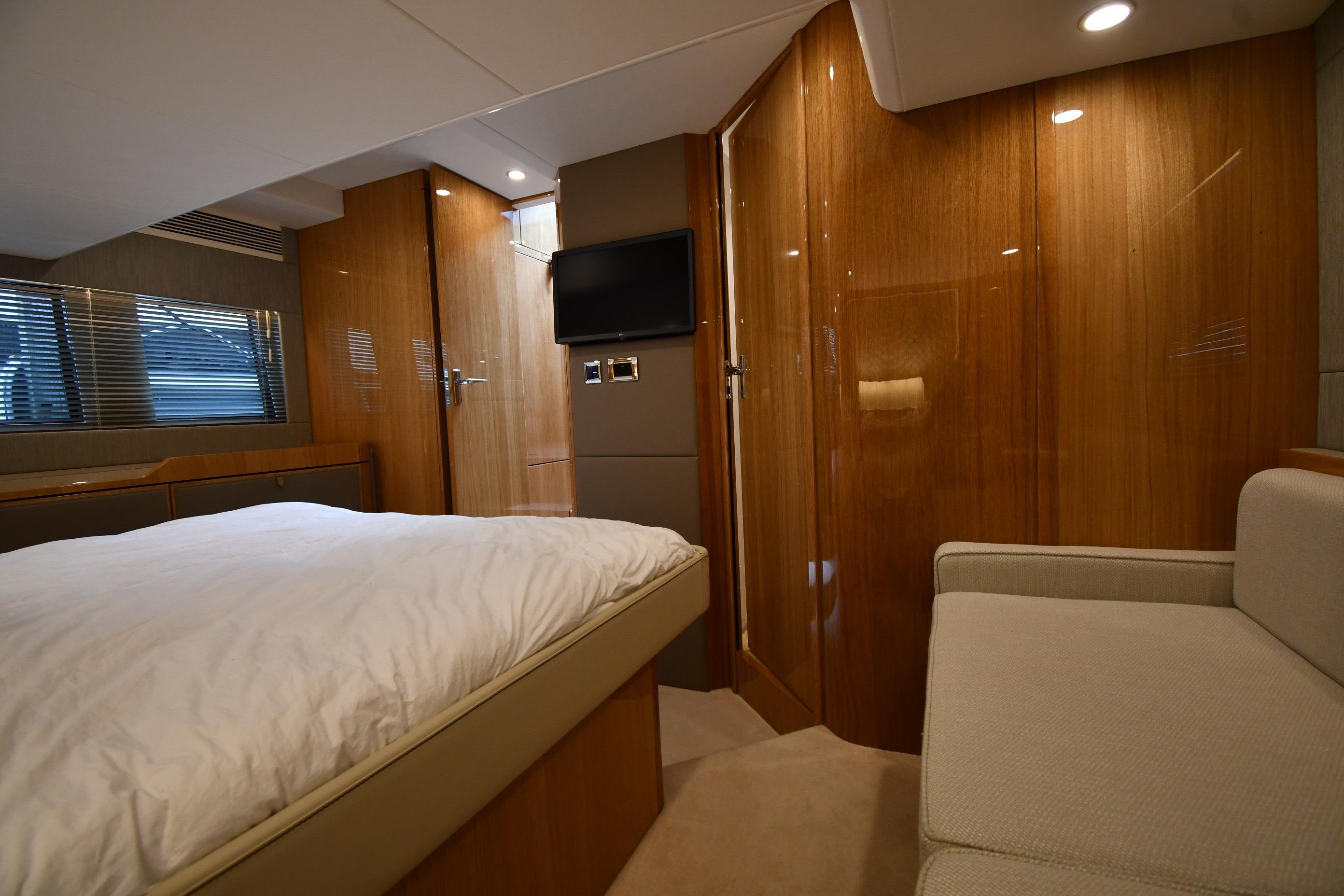 Luxurious cabin interior of 2024 Fairline G50 Targa yacht with wood paneling and modern amenities.