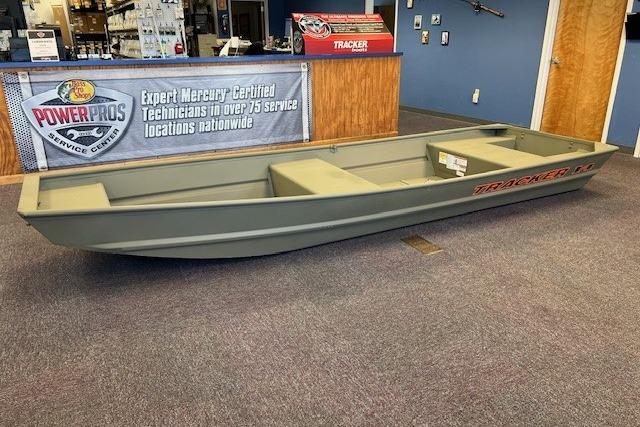 2026 Tracker Grizzly 14 Jon boat displayed indoors at a service center.