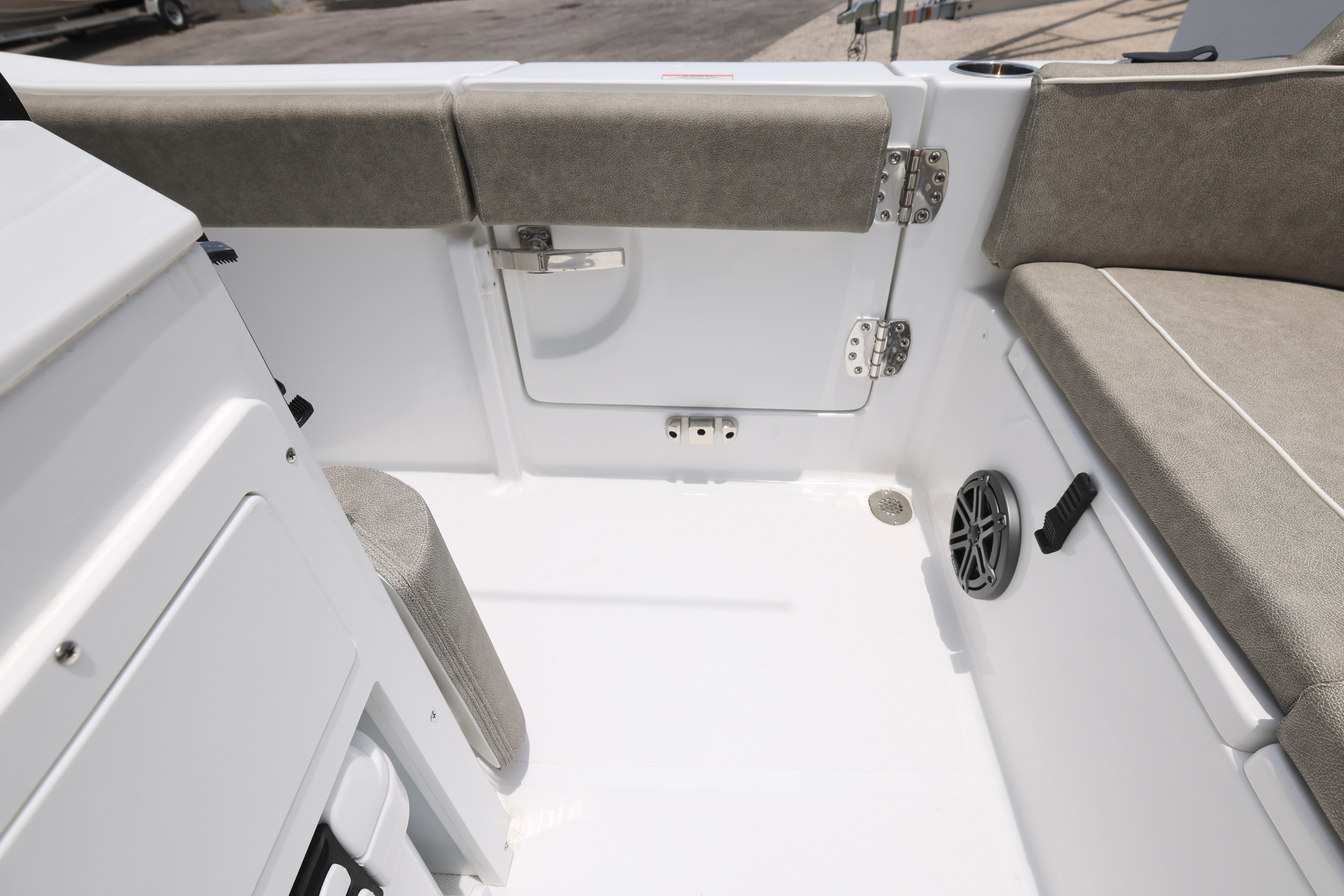 2026 Sea Hunt Ultra 245 SE boat interior with cushioned seating and storage compartment.