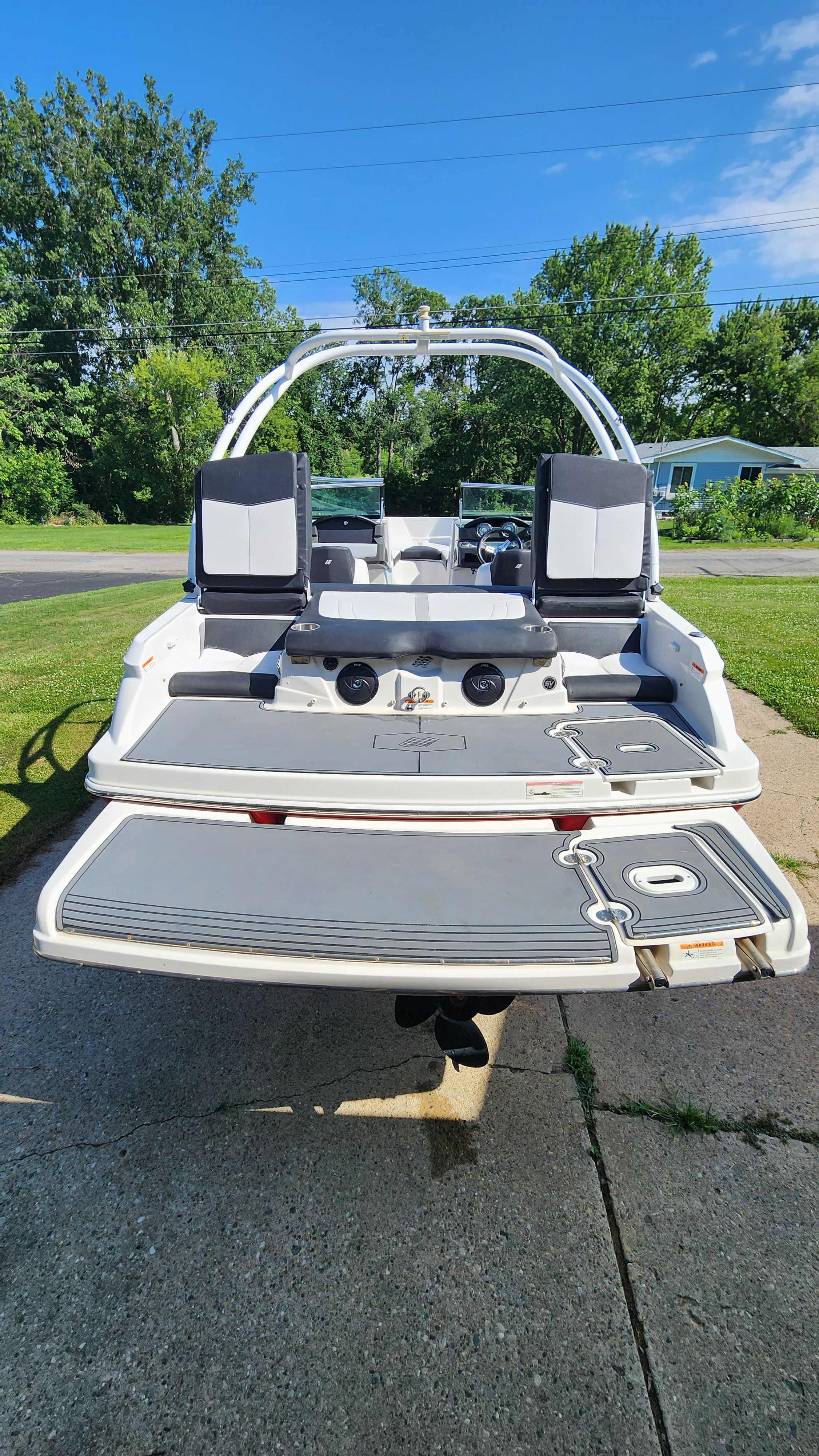 The image shows a 2015 Four Winns H190 boat with a spacious rear area and two seats.
