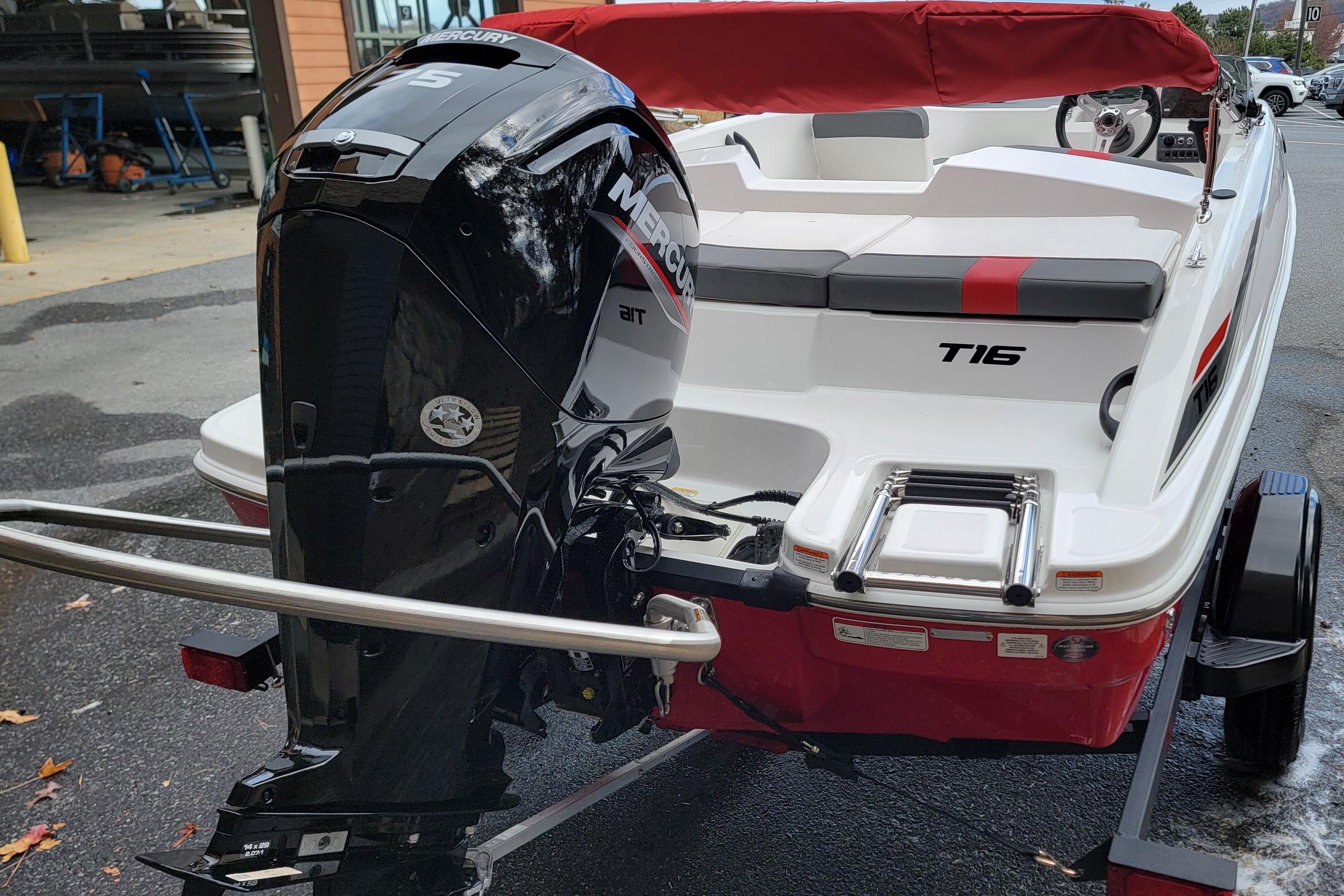 2026 Tahoe T16 boat with Mercury outboard motor, red and white design, parked on trailer.