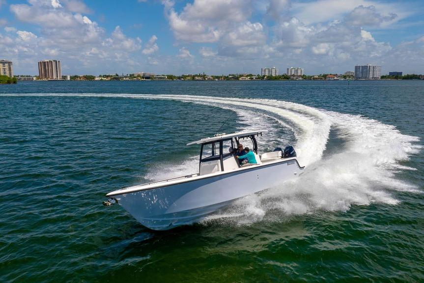 2027 Reef Runner 340 boat cruising on a sunny day in open water.