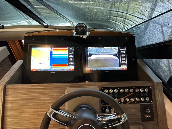 2019 Tiara Yachts C53 helm with dual navigation screens and control panel.