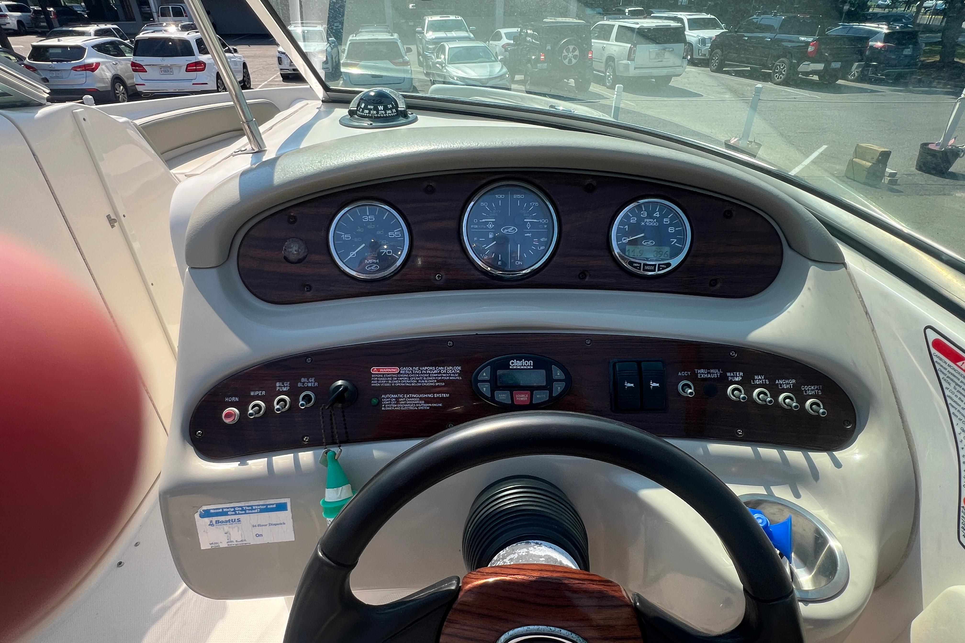 Dashboard of a 2005 Sea Ray 240 Sundeck boat with gauges and controls.