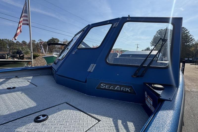2026 SeaArk Dynasty 2.0 boat with blue cabin and American flag in background.