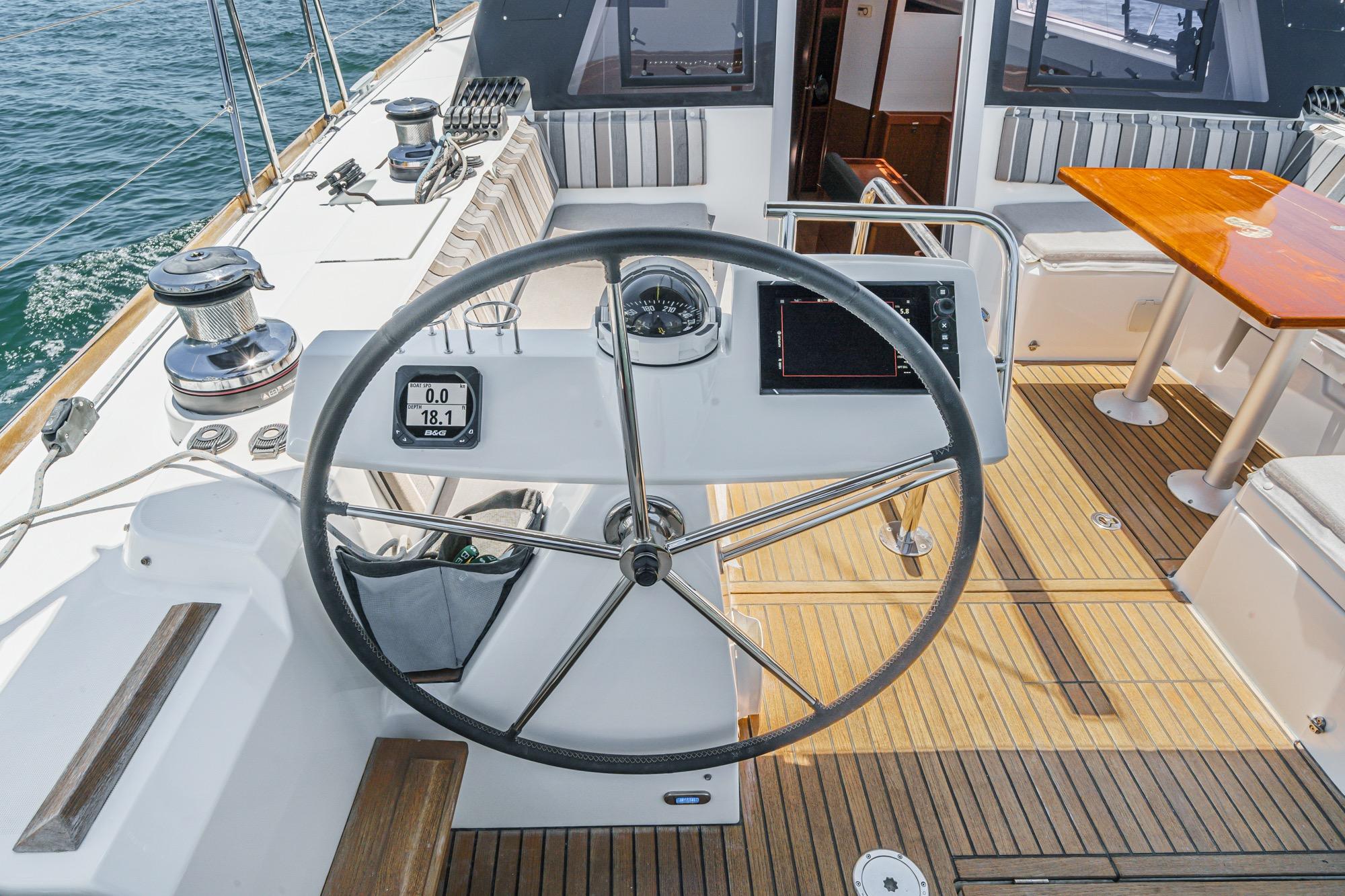 Cockpit of 2017 Beneteau Sense 50 yacht with steering wheel and navigation instruments.