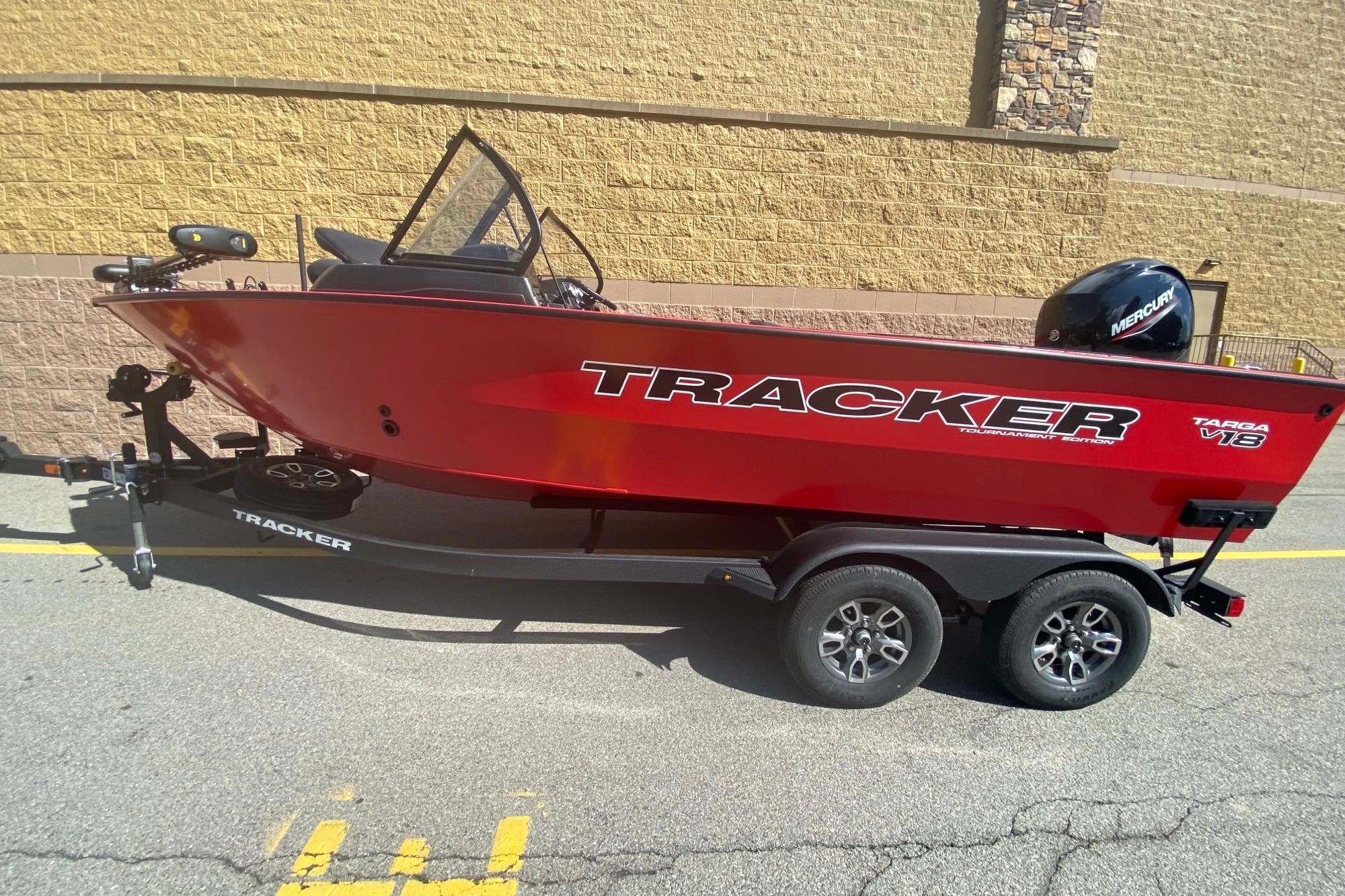 2026 Tracker Targa V-18 WT boat on trailer, vibrant red color, parked outdoors.