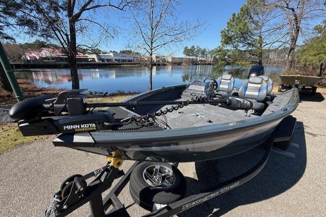 2026 Ranger VS1665SC fishing boat by a scenic lake, featuring Minn Kota motor.