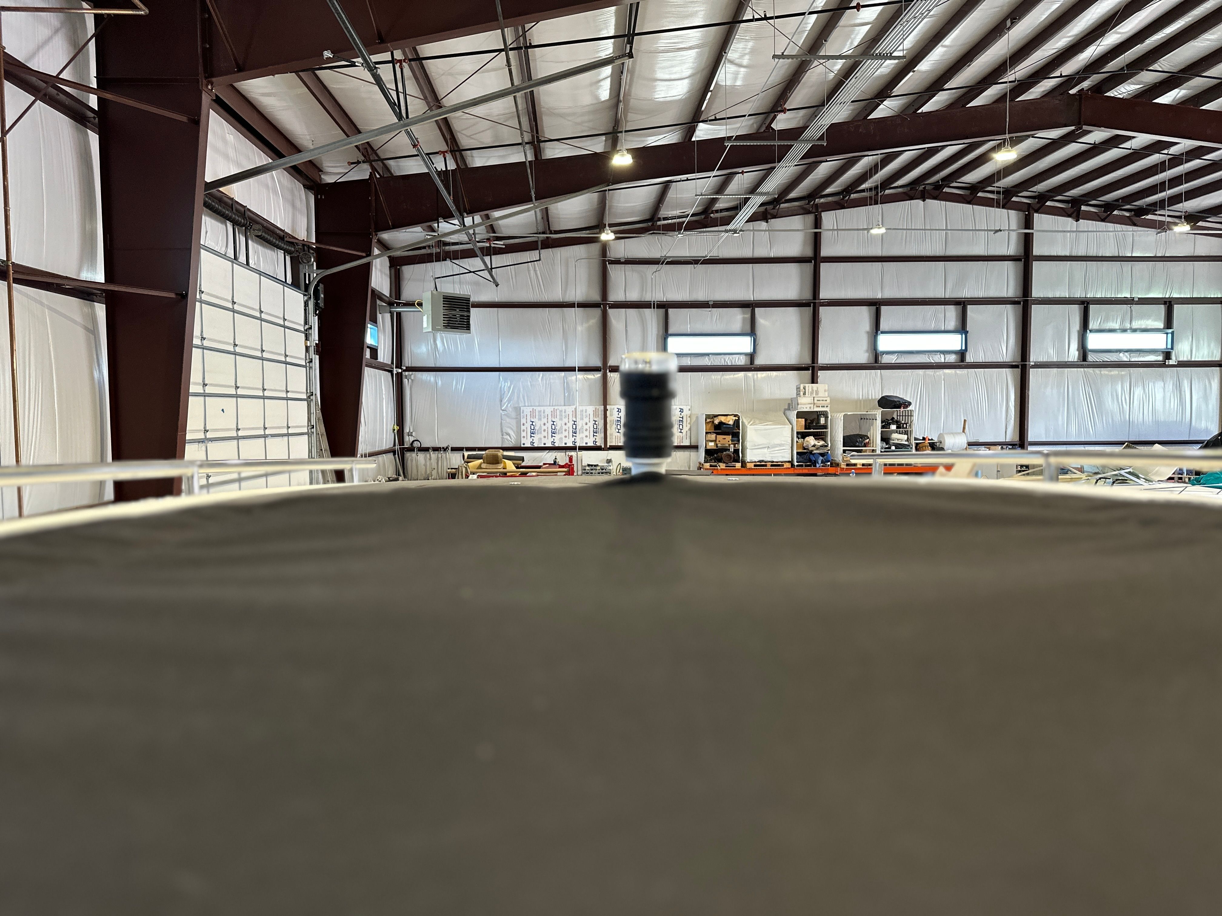 Interior view of a boat workshop with a 2021 Scarab 255 Open ID.