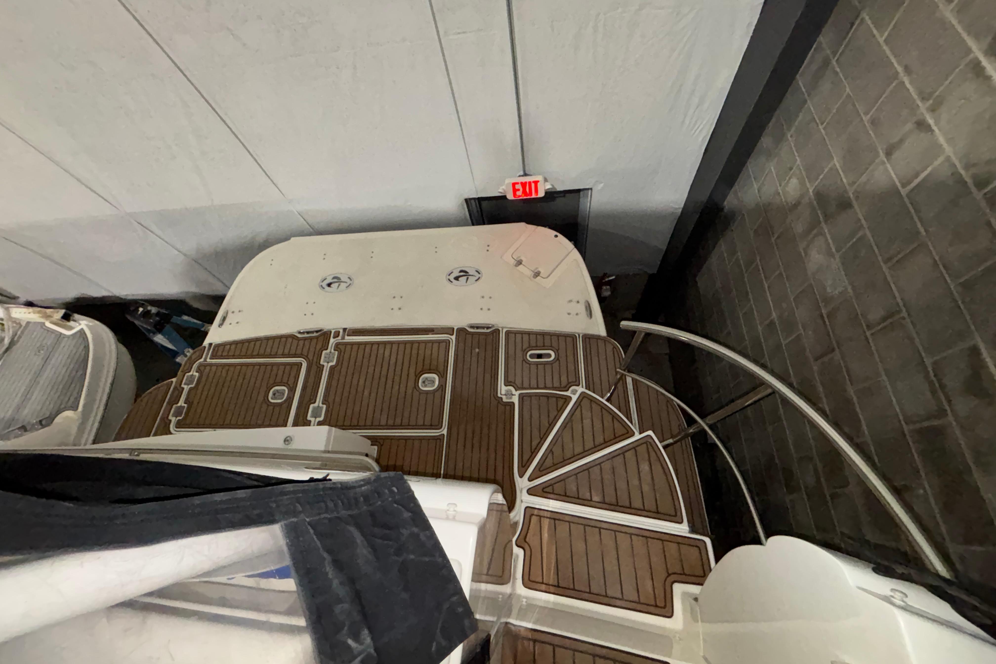2004 Cruisers Yachts 405 Express Motoryacht with wooden deck, viewed from above in storage.