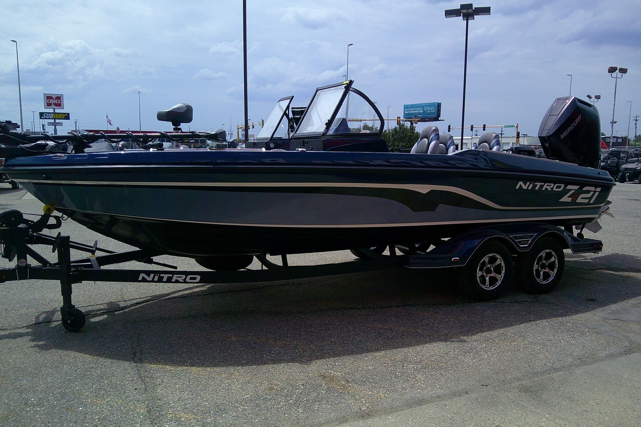2026 Nitro ZV21 Pro boat on trailer in parking lot, side view.