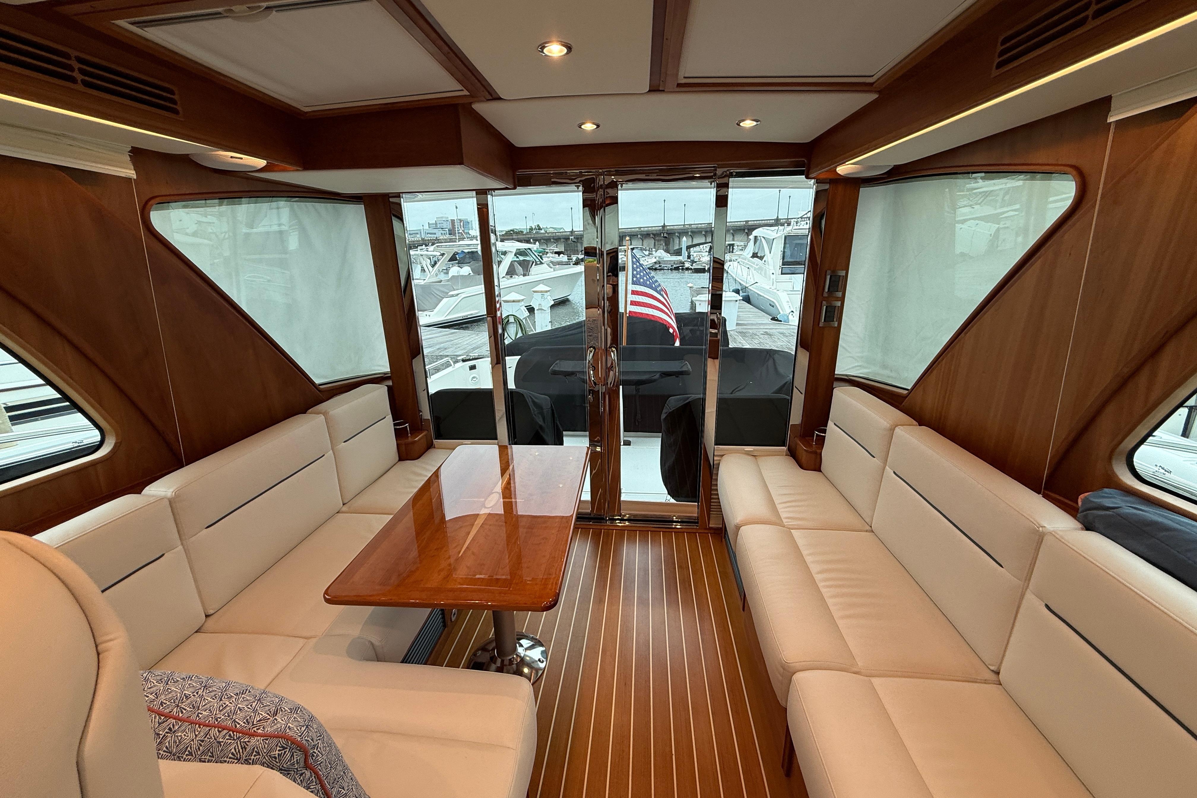 Luxurious interior of 2023 Sabre 43 Salon Express yacht with elegant seating and wooden accents.