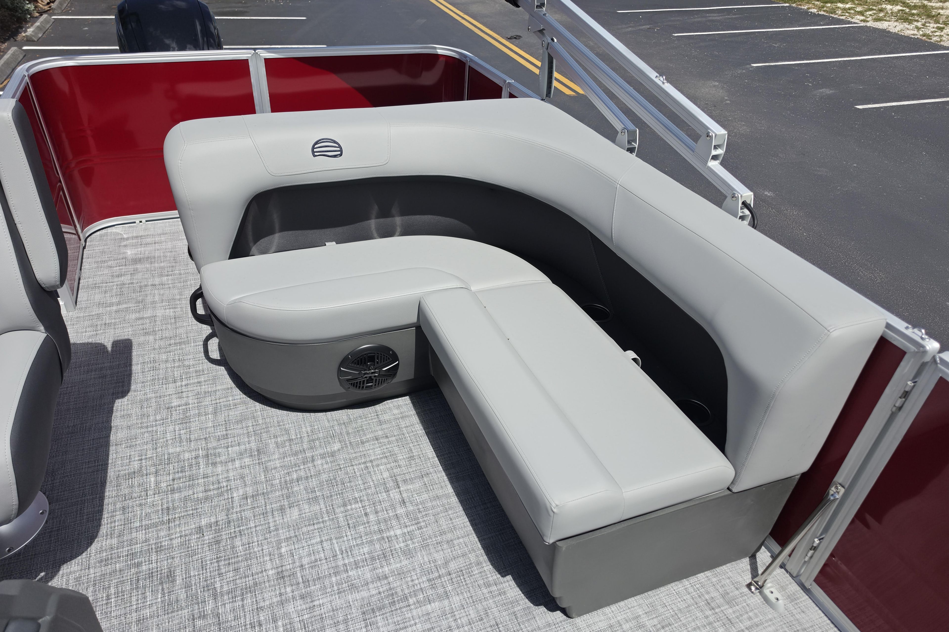 2026 Sun Tracker Party Barge 18 DLX with gray seating and red paneling.