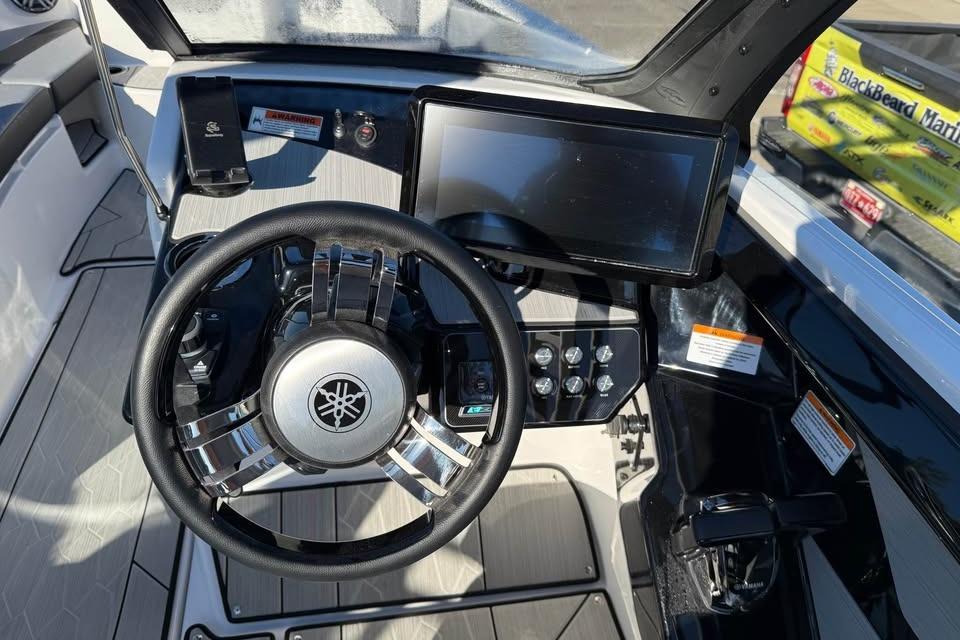 2026 Yamaha Boats 222XD dashboard with steering wheel and touchscreen display.