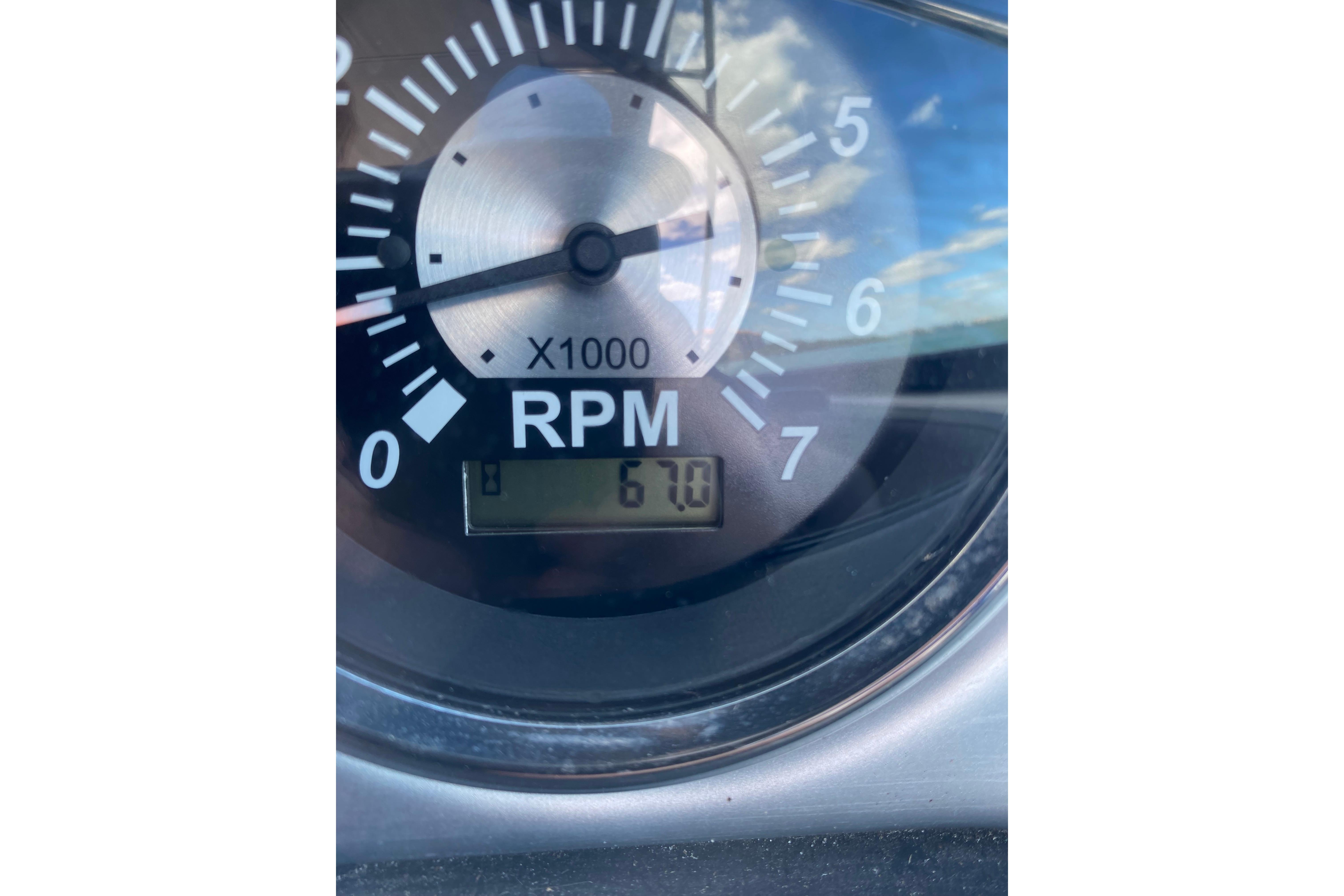 Close-up of 2023 NauticStar 243 DC tachometer showing 670 RPM.
