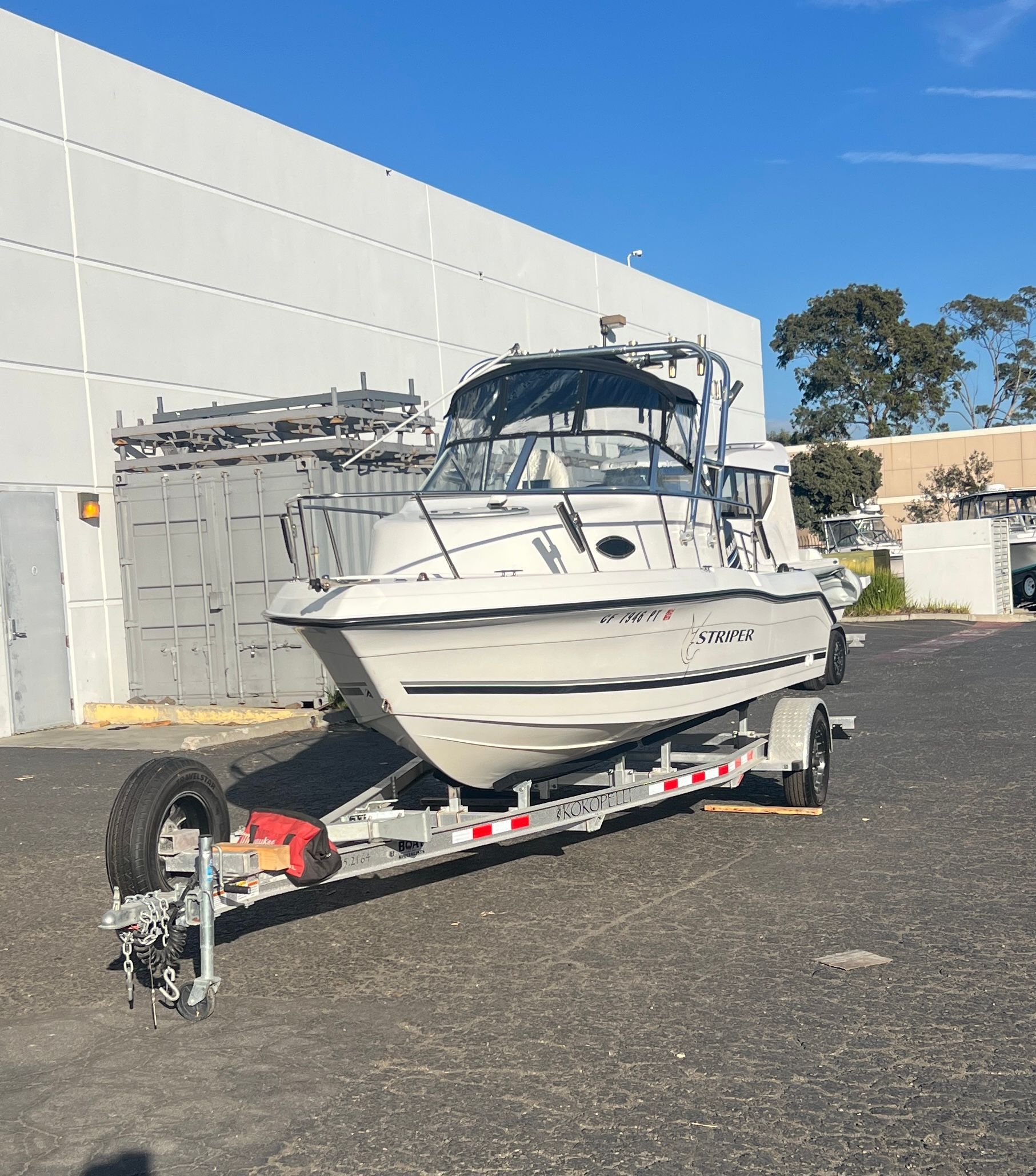 A 2001 Seaswirl Striper 1851 WA on a trailer, parked on a paved lot.