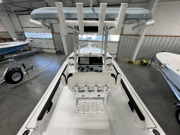 2025 Tidewater 2300 Carolina Bay boat interior in showroom, featuring rod holders and console.