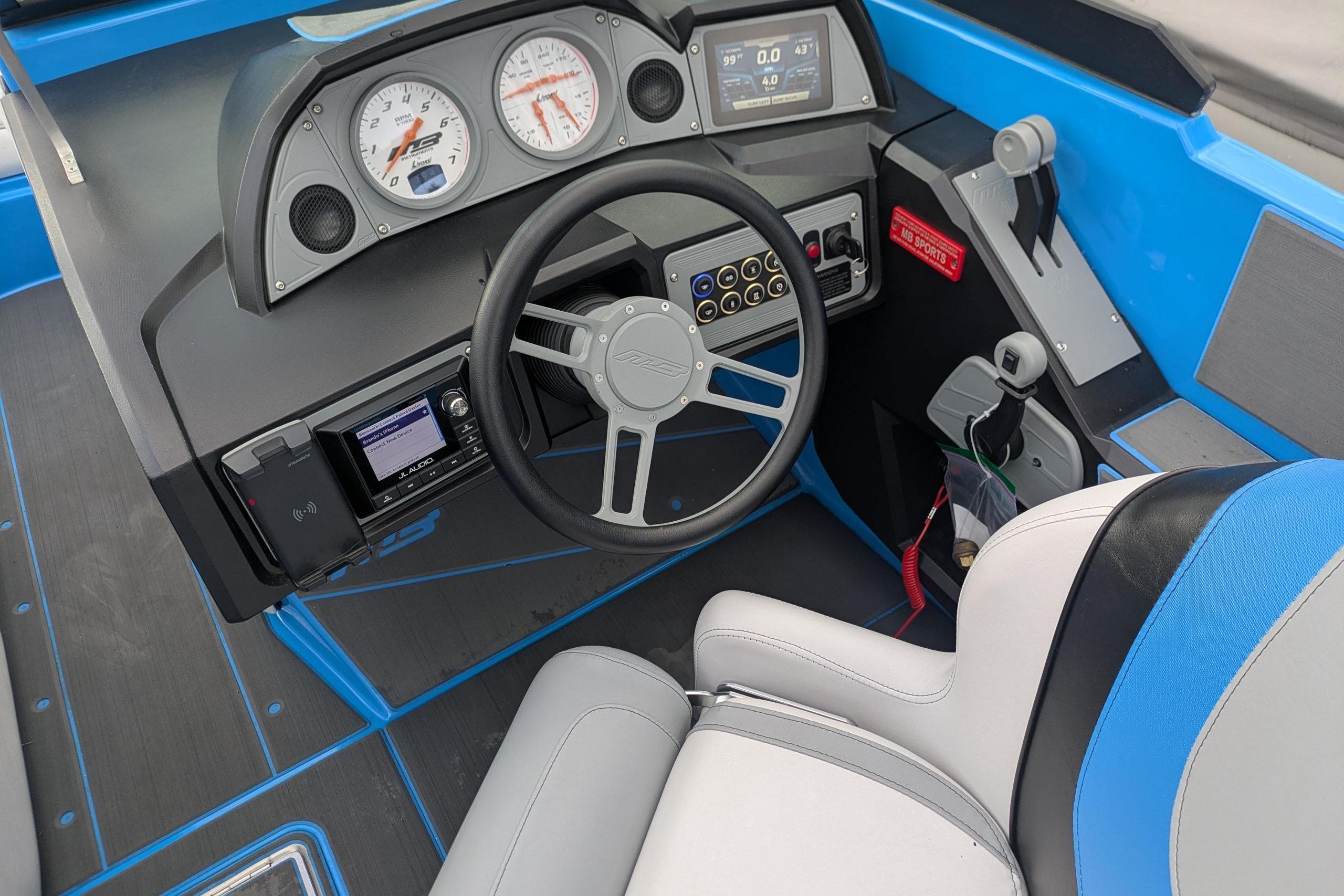 Cockpit of 2022 MB F22 Alpha boat with modern controls and blue accents.