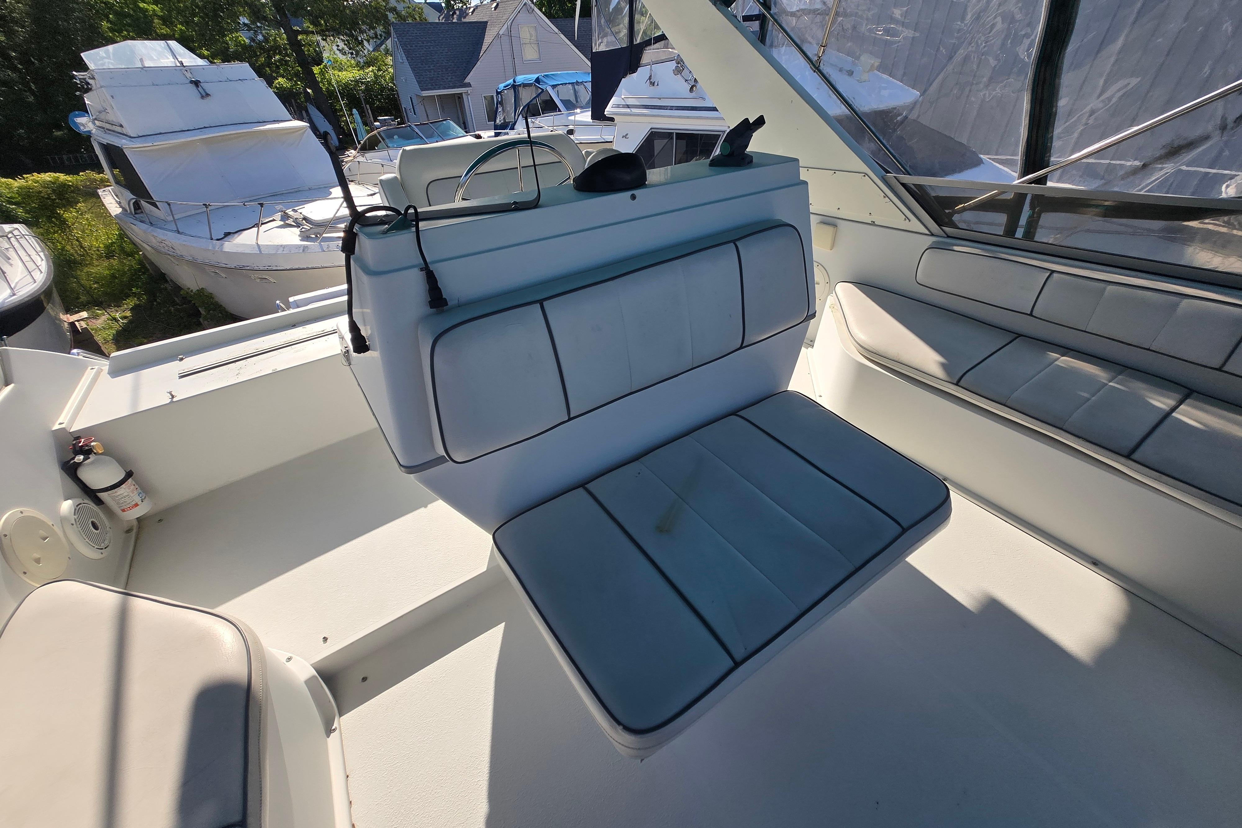 Interior of a 1994 Carver 380 Santego yacht with white seating and helm area.