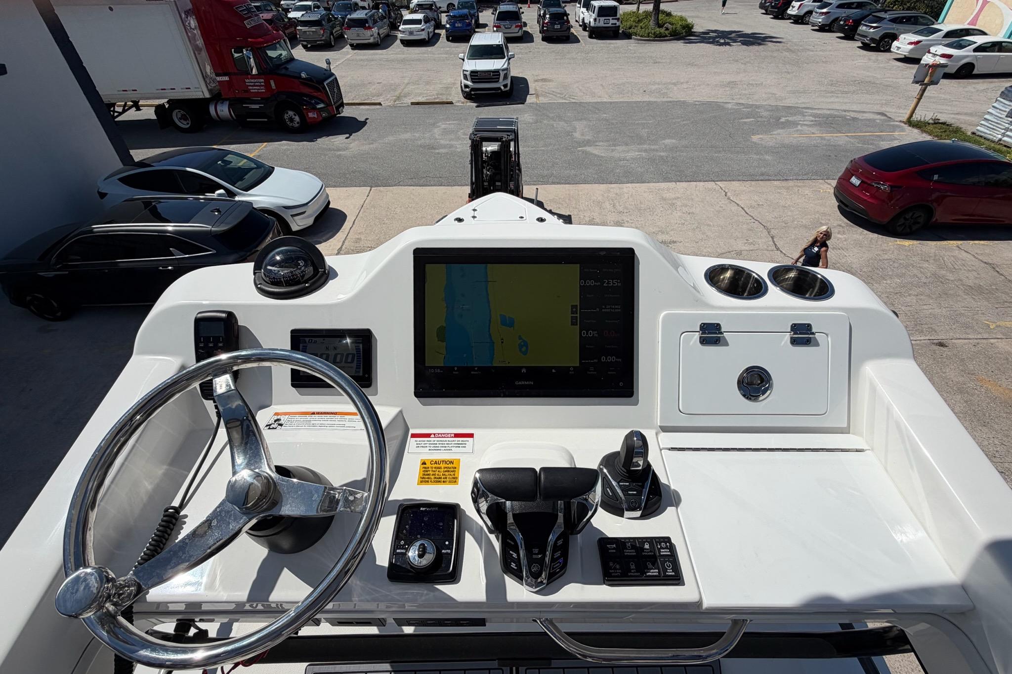 2024 Everglades 335 Center Console boat dashboard with steering wheel and navigation display.