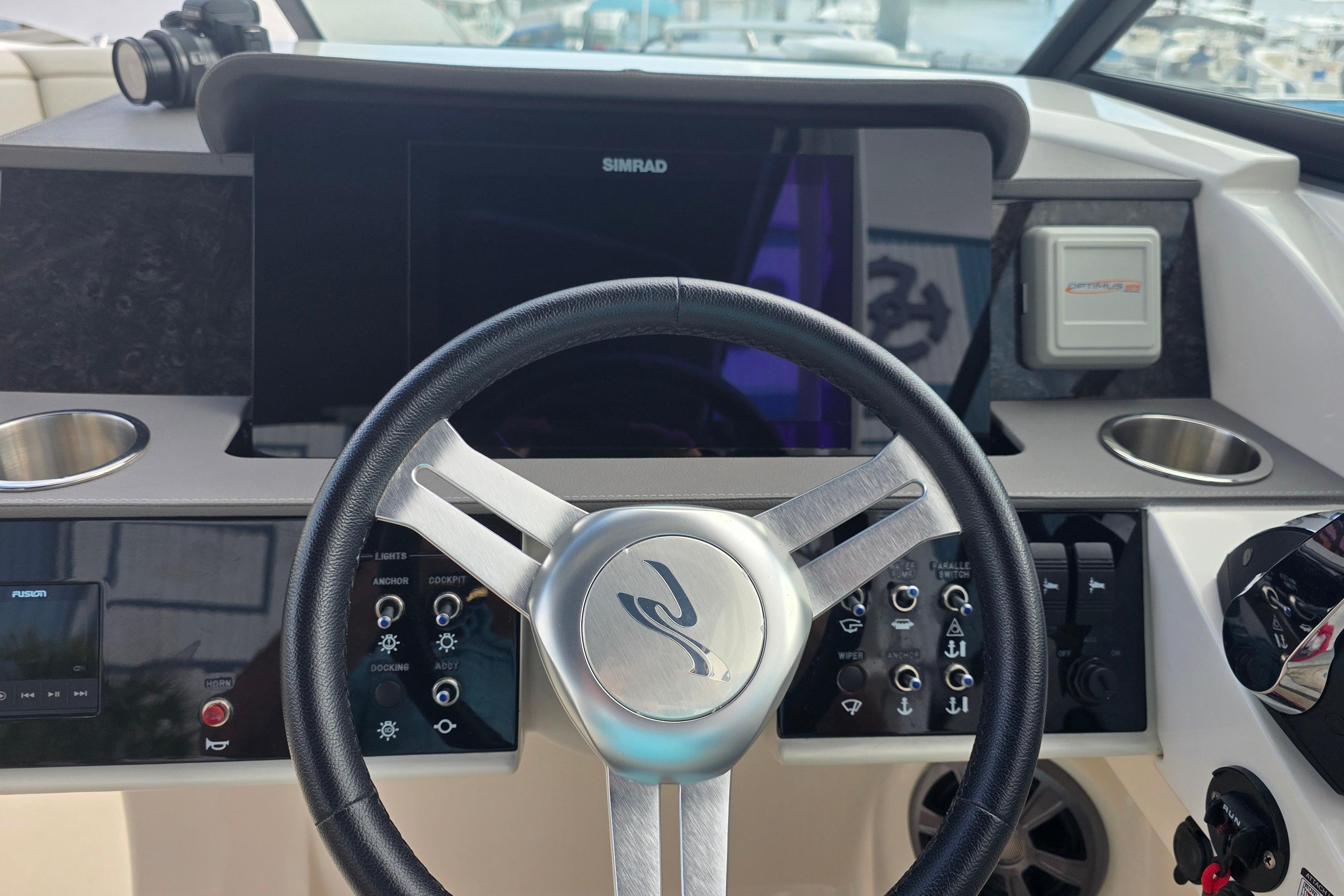 2021 Sea Ray SDX 290 Outboard helm with steering wheel and control panel.