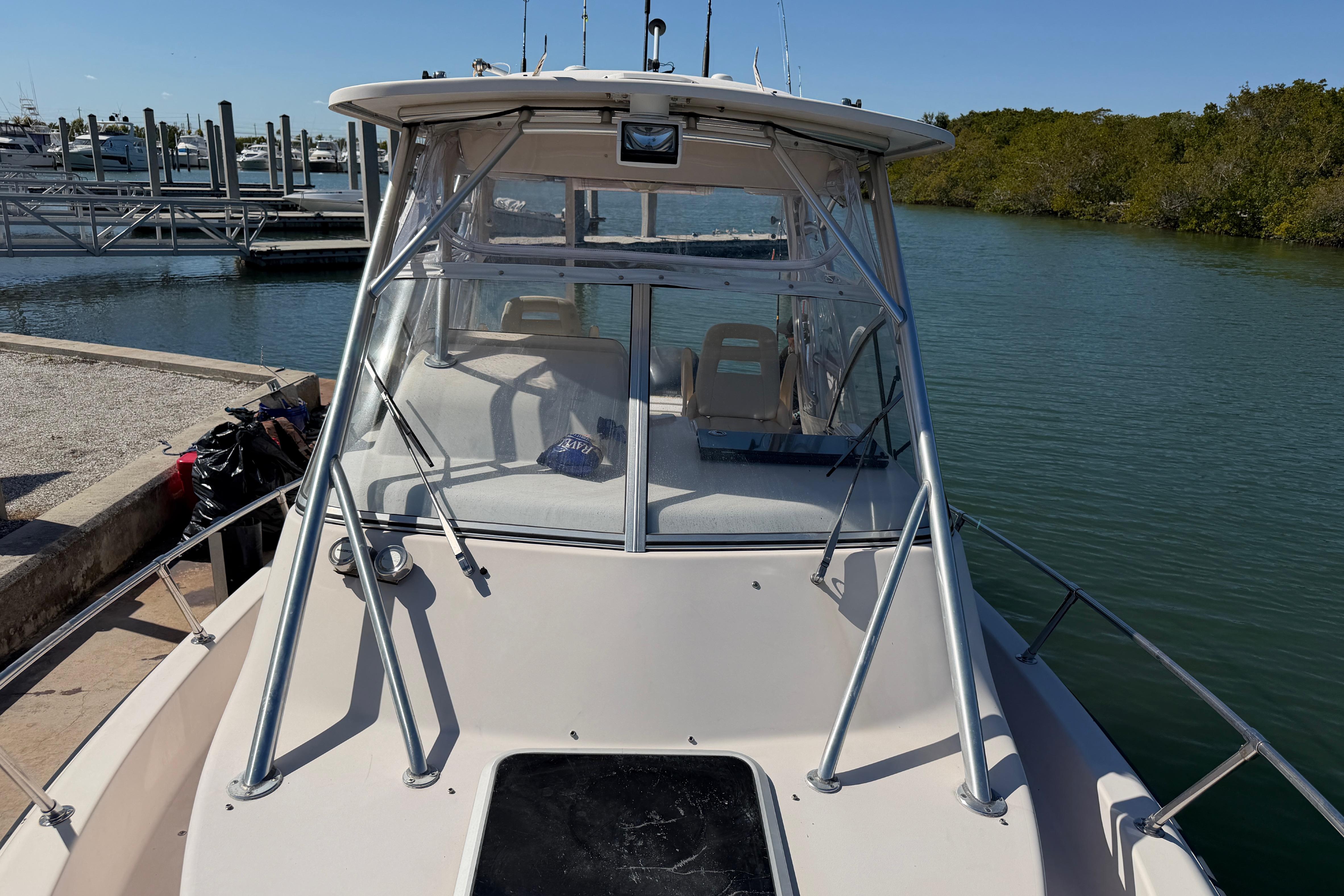 2006 Grady-White Sailfish 282 boat docked by the water, showcasing its deck and cabin.