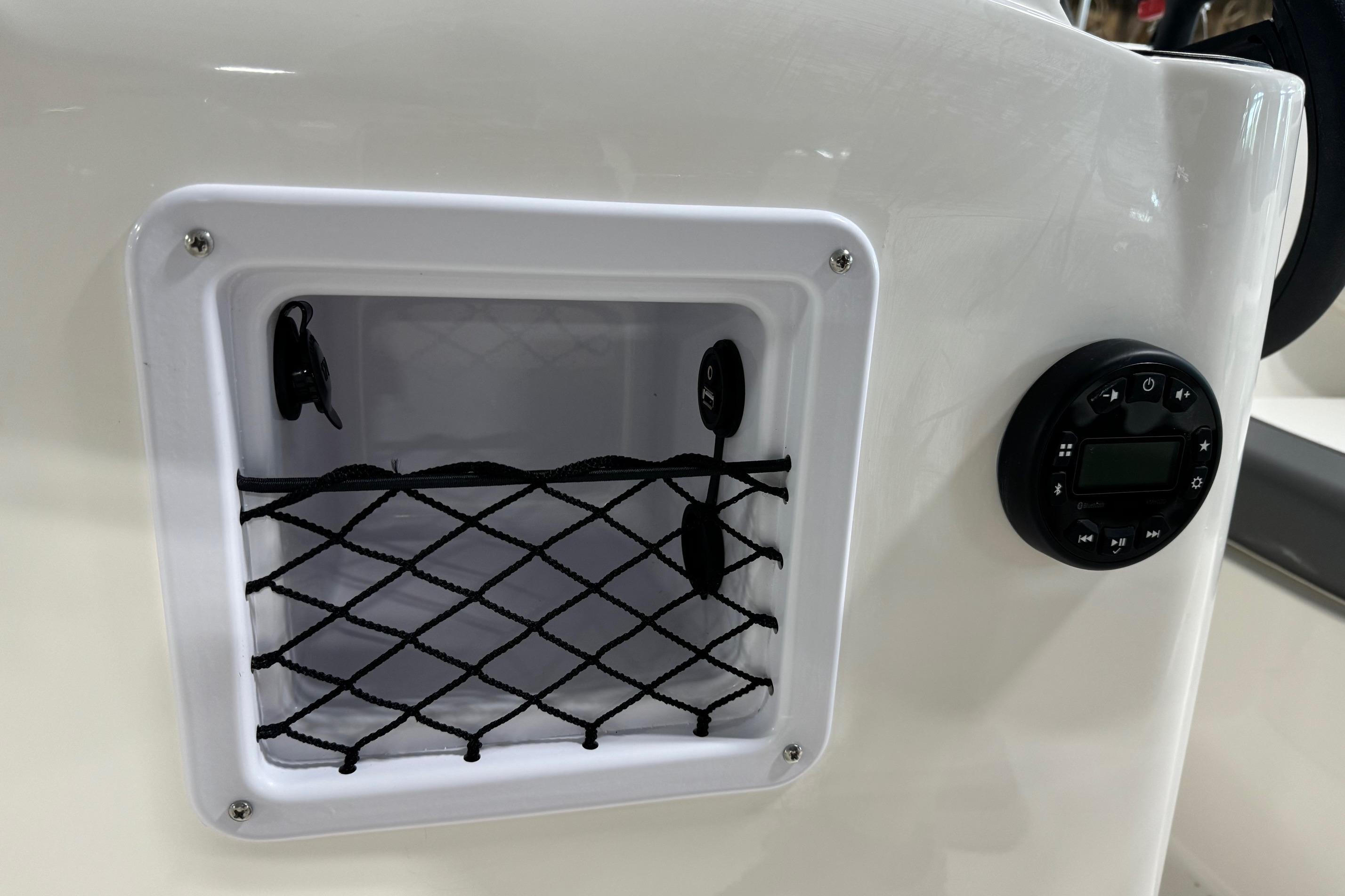 2025 Bayliner Element E18 boat storage compartment and control panel.